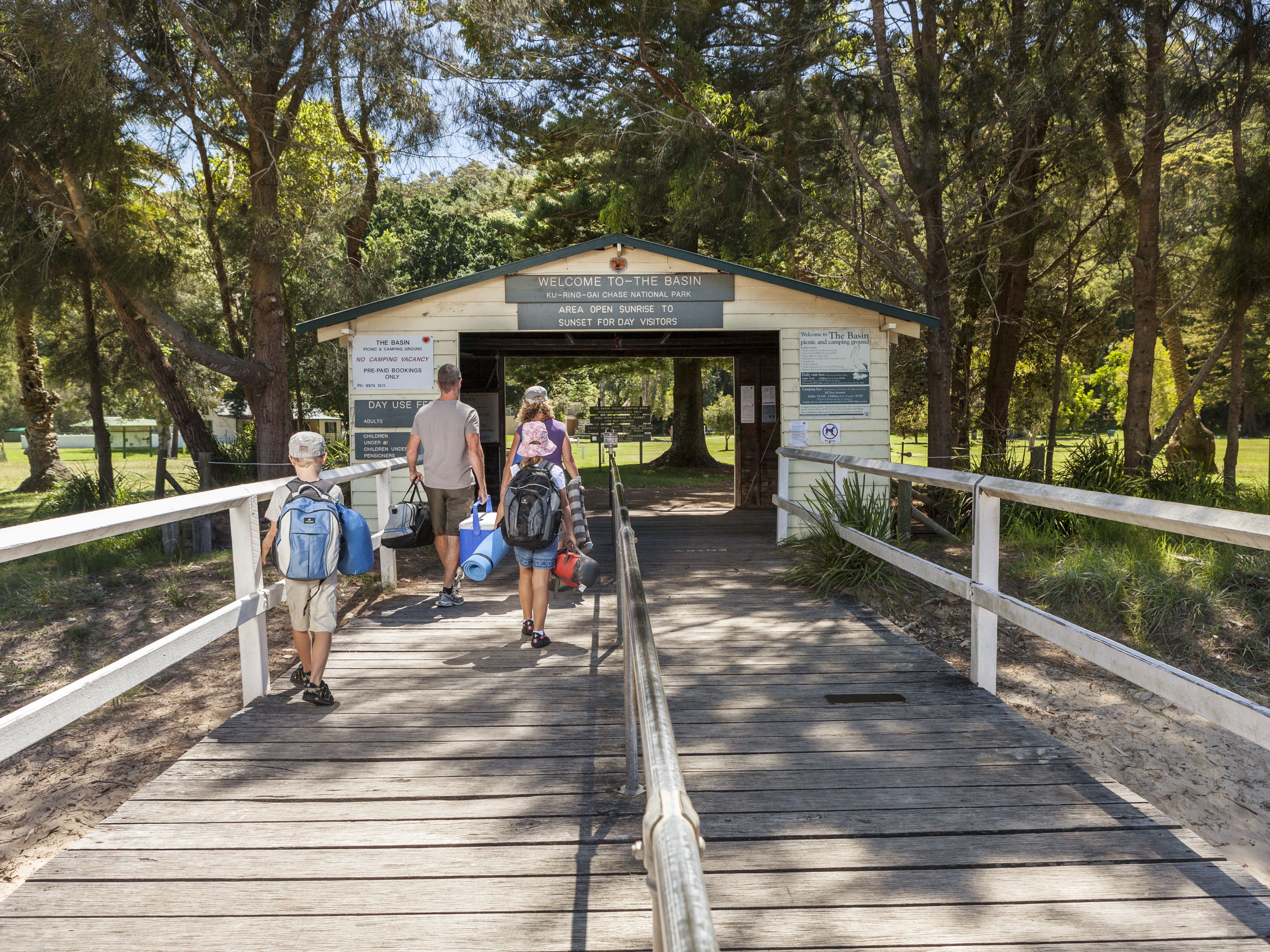 Family walking on the jetty at The Basin campground, Ku-ring-gai Chase National Park. Photo: David Finnegan/OEH