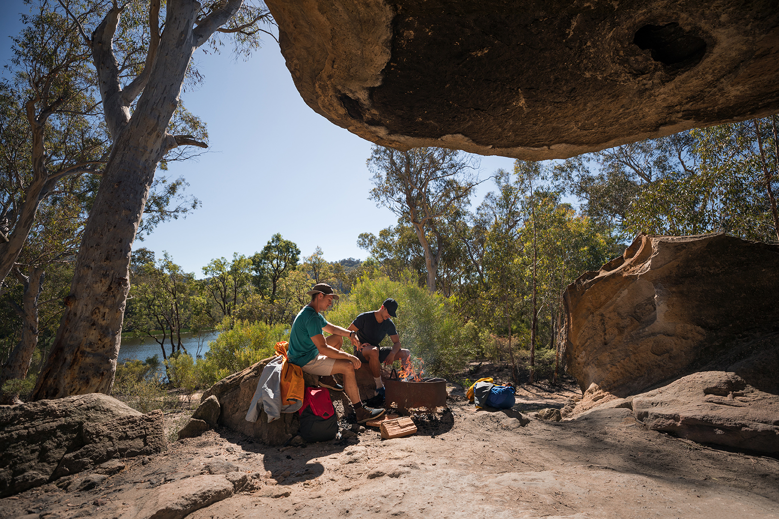 Two guys around a designated fire pit at Wollemi National Park. Credit: Daniel Tran/DCCEEW © Studio Bilby