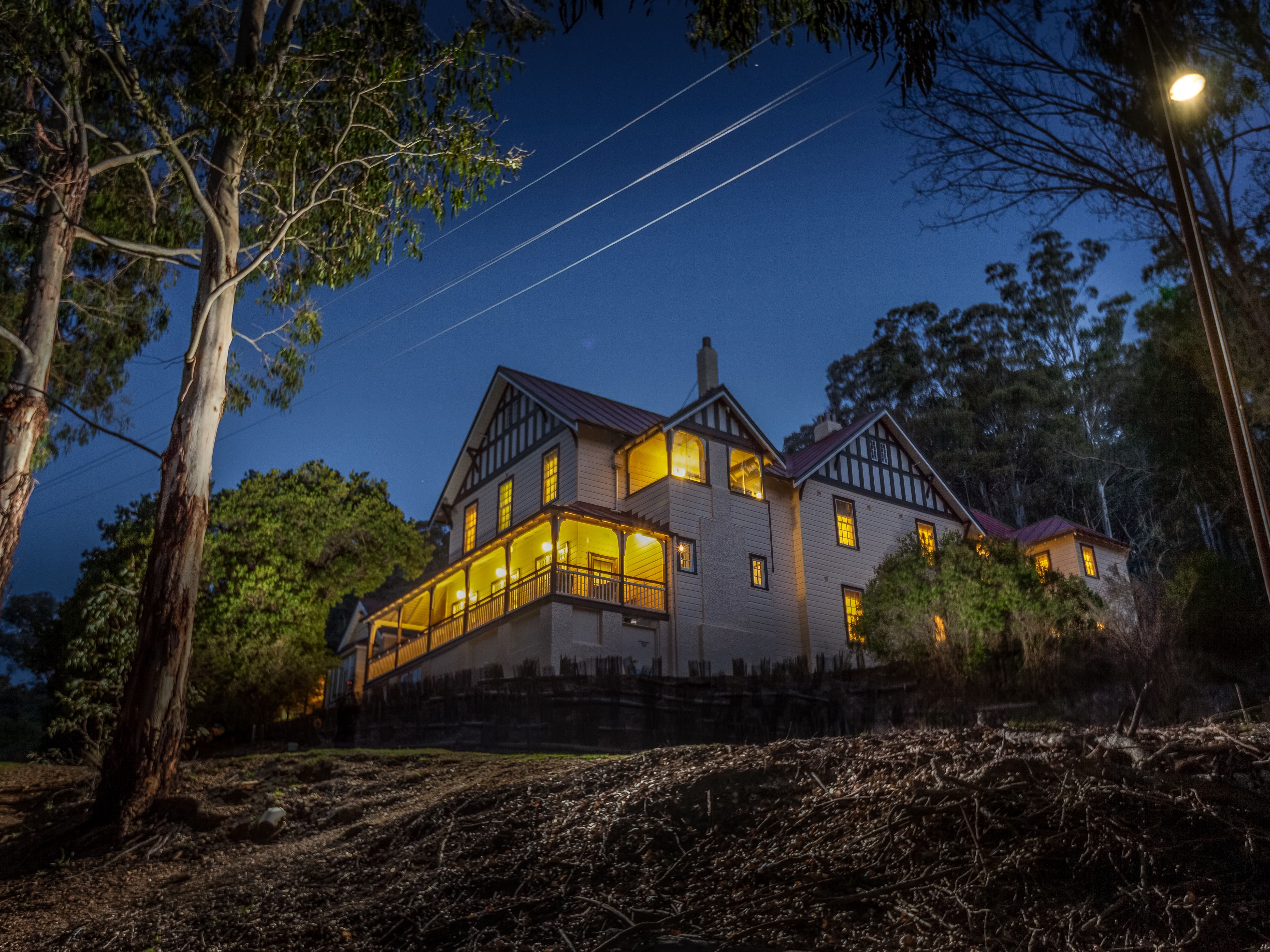 Large heritage house at dusk, Yarrangobilly Caves House, Kosciuszko National Park. Photo: Murray Vanderveer/DPIE