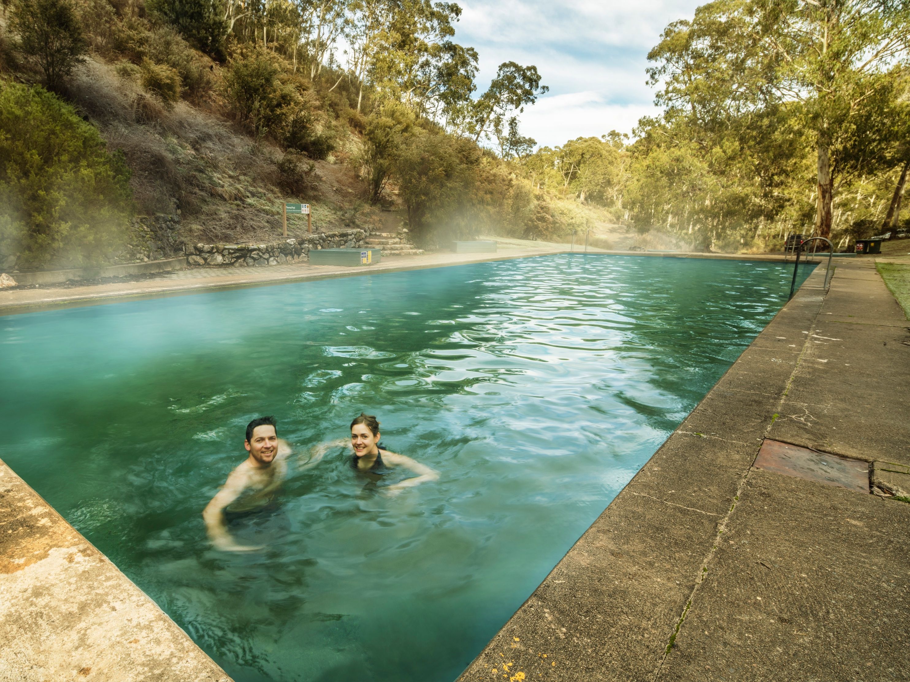 Two people swimming in the Yarrangobilly Caves thermal pool, Yarrangobilly area in Kosciuszko National Park. Photo: Murray Vanderveer/DPIE