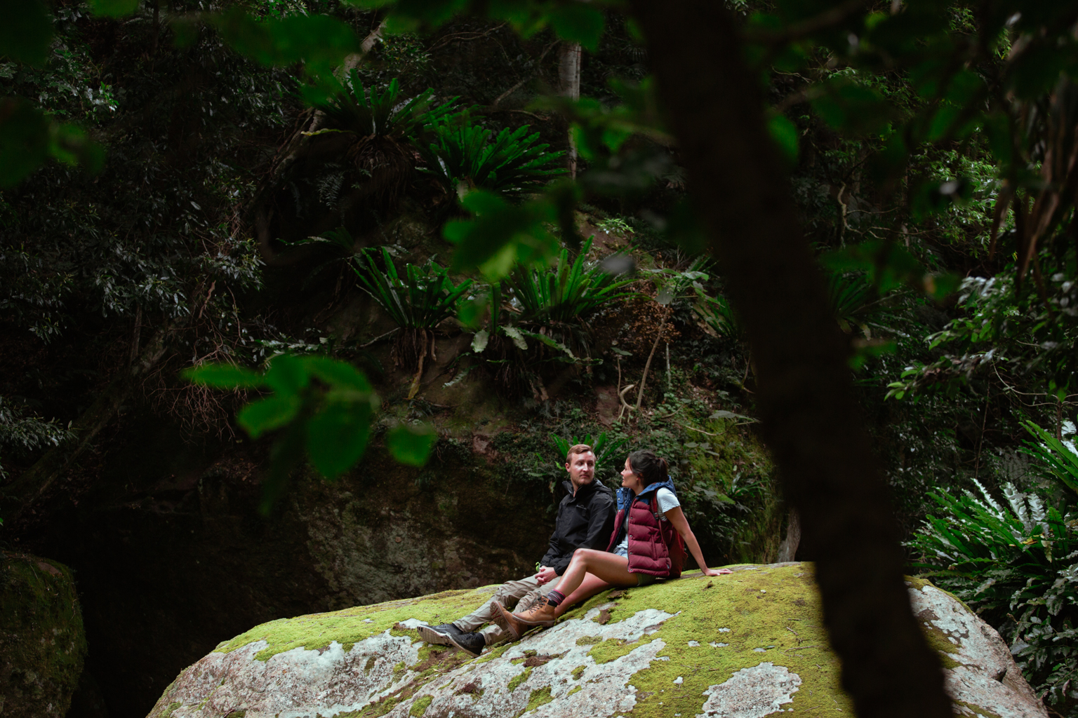 Two people relaxing on a large rock, Buderoo National Park. Photo: Tim Clark