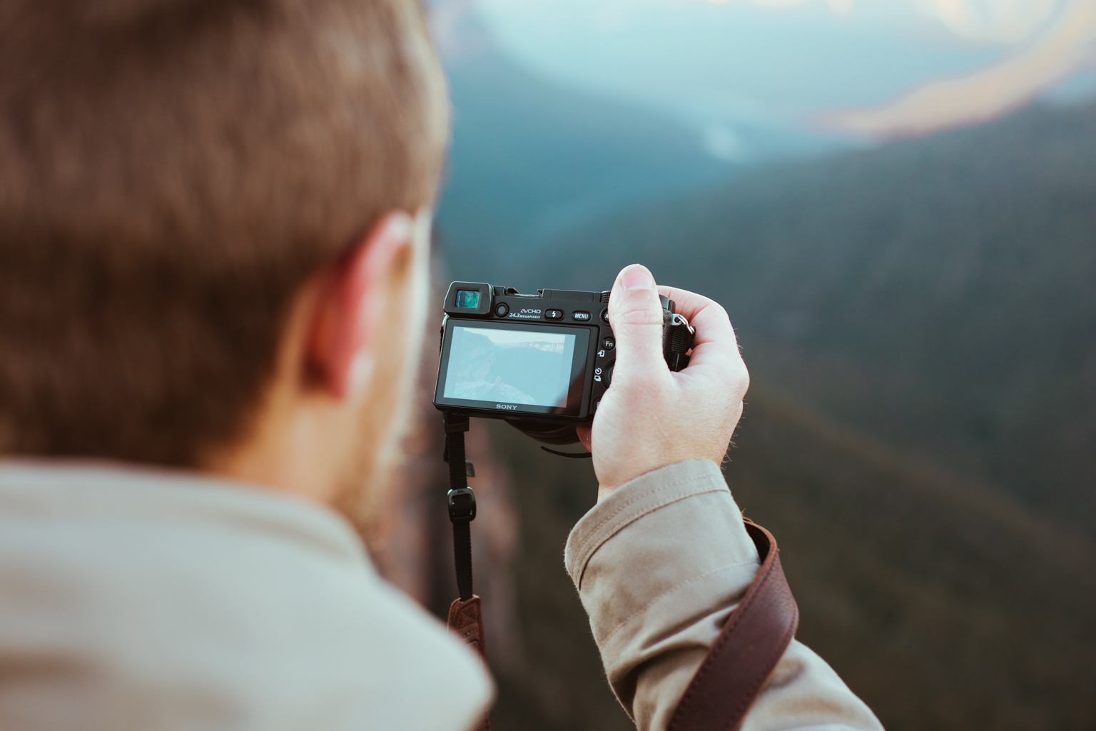 Man taking a photo of the view, Blue Mountains National Park. Photo: Tim Clark