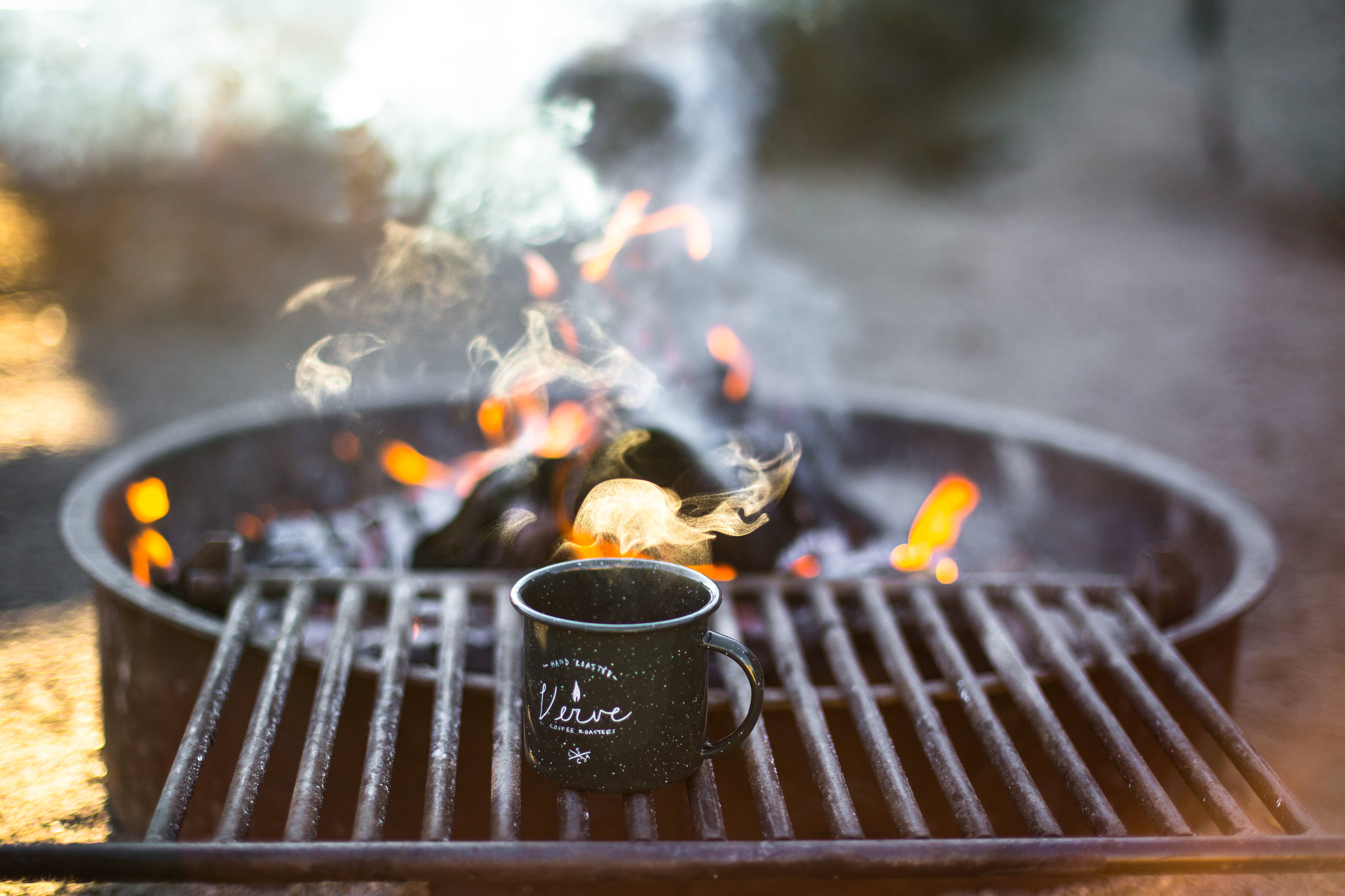 Campsite fire and hot beverage in the foreground. Photo: Tim Wright