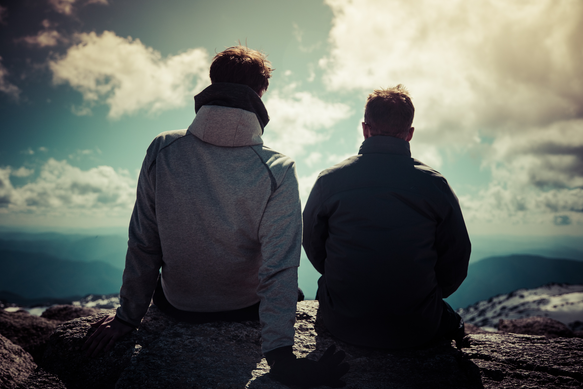 Two people sitting on the Mount Kosciuszko Summit walk, Kosciuszko National Park. Photo: Daniel Parsons/DCCEEW © Studio Bilby