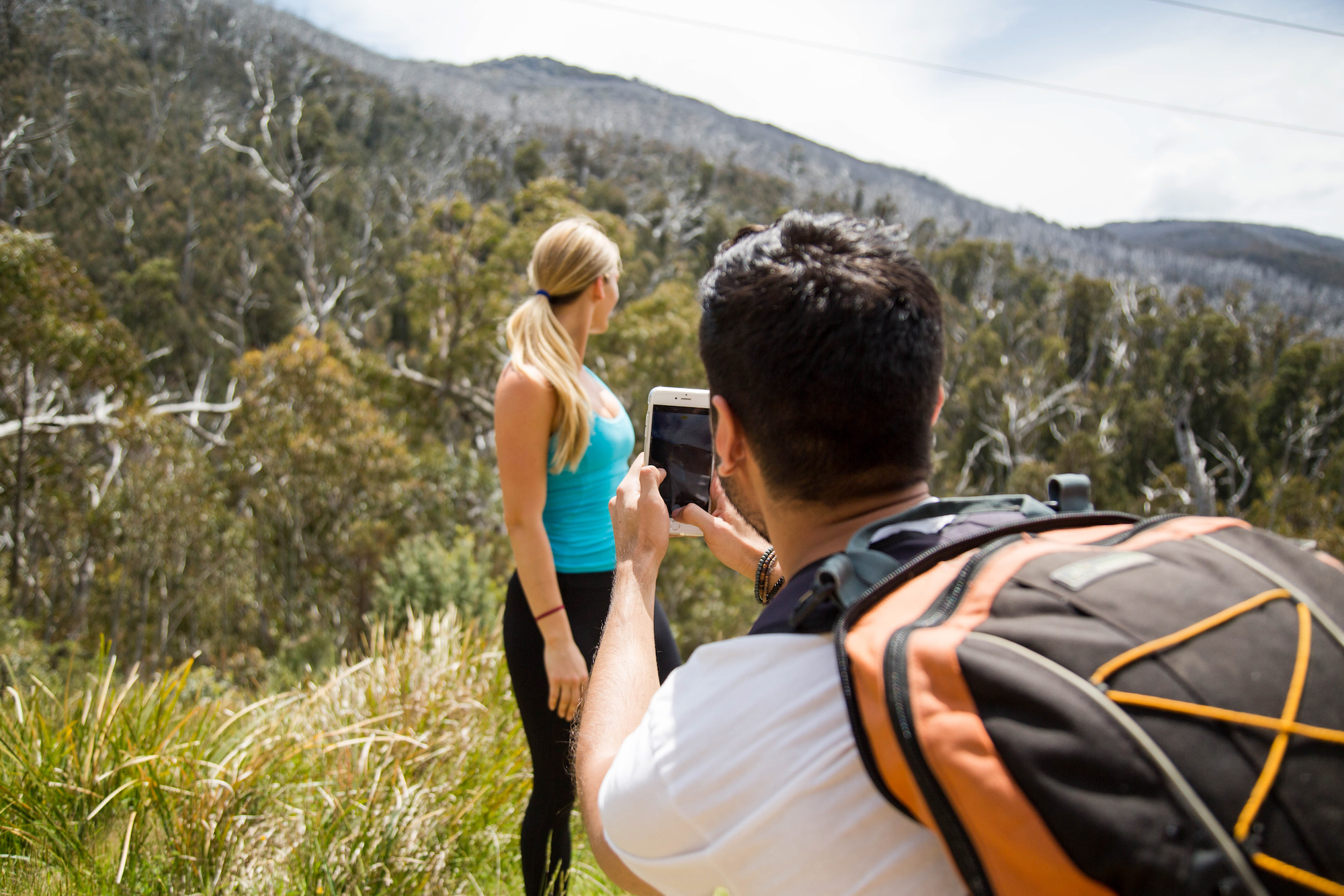 People taking photos of each other, Kosciuszko National Park. Photo: Boen Ferguson/DPIE