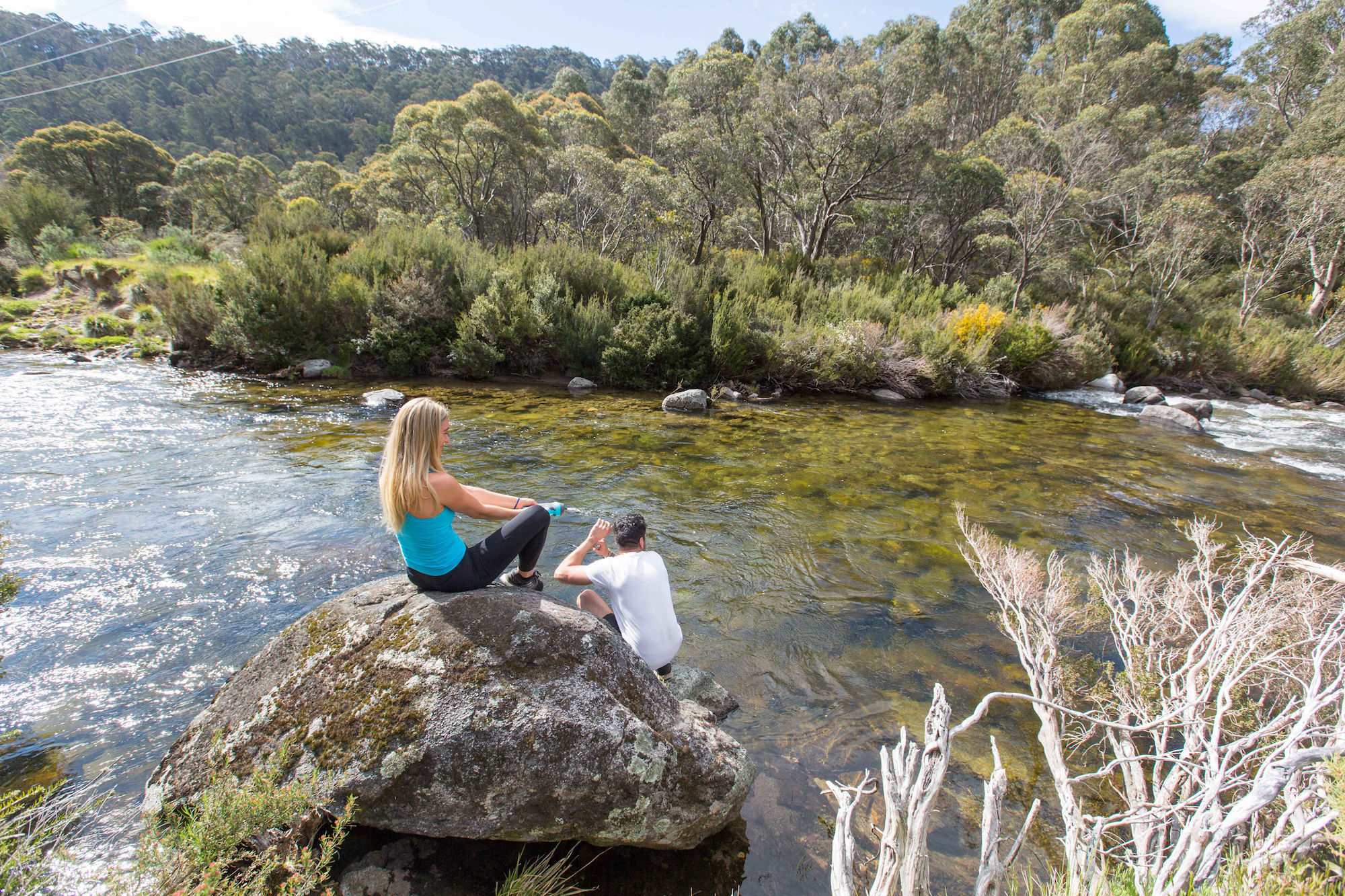 People sitting by a stream, Kosciuszko National Park. Photo: Boen Ferguson/DPIE