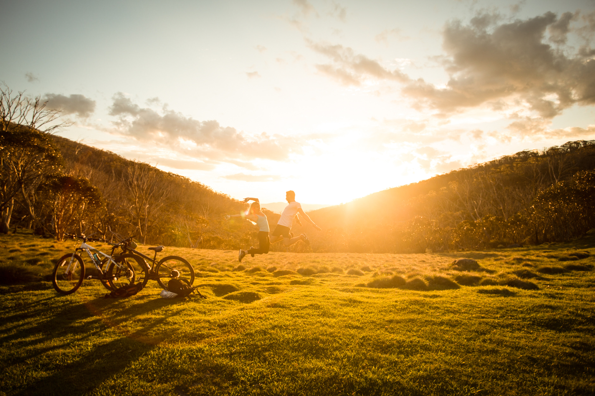 People mountain biking and stopping for a break, Kosciuszko National Park. Photo: Boen Ferguson/DPIE