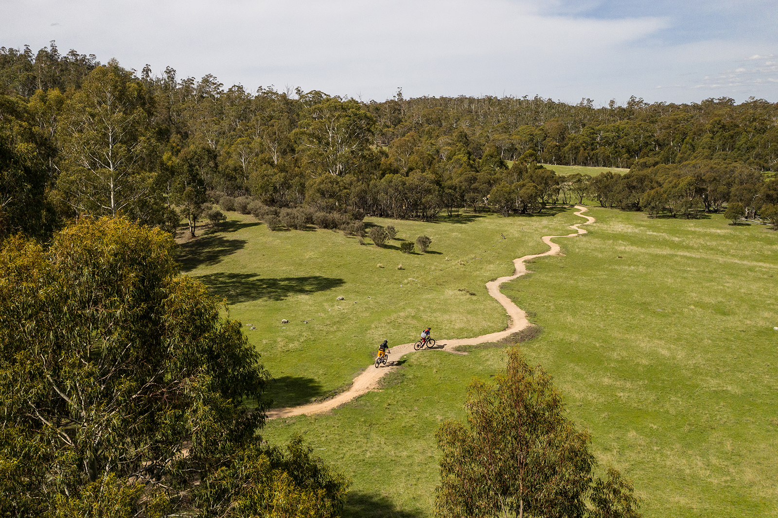 Aerial view of two guys riding the Thredbo Valley track, Thredbo-Perisher area in Kosciuszko National Park. Photo credit: Rob Mulally/DPIE