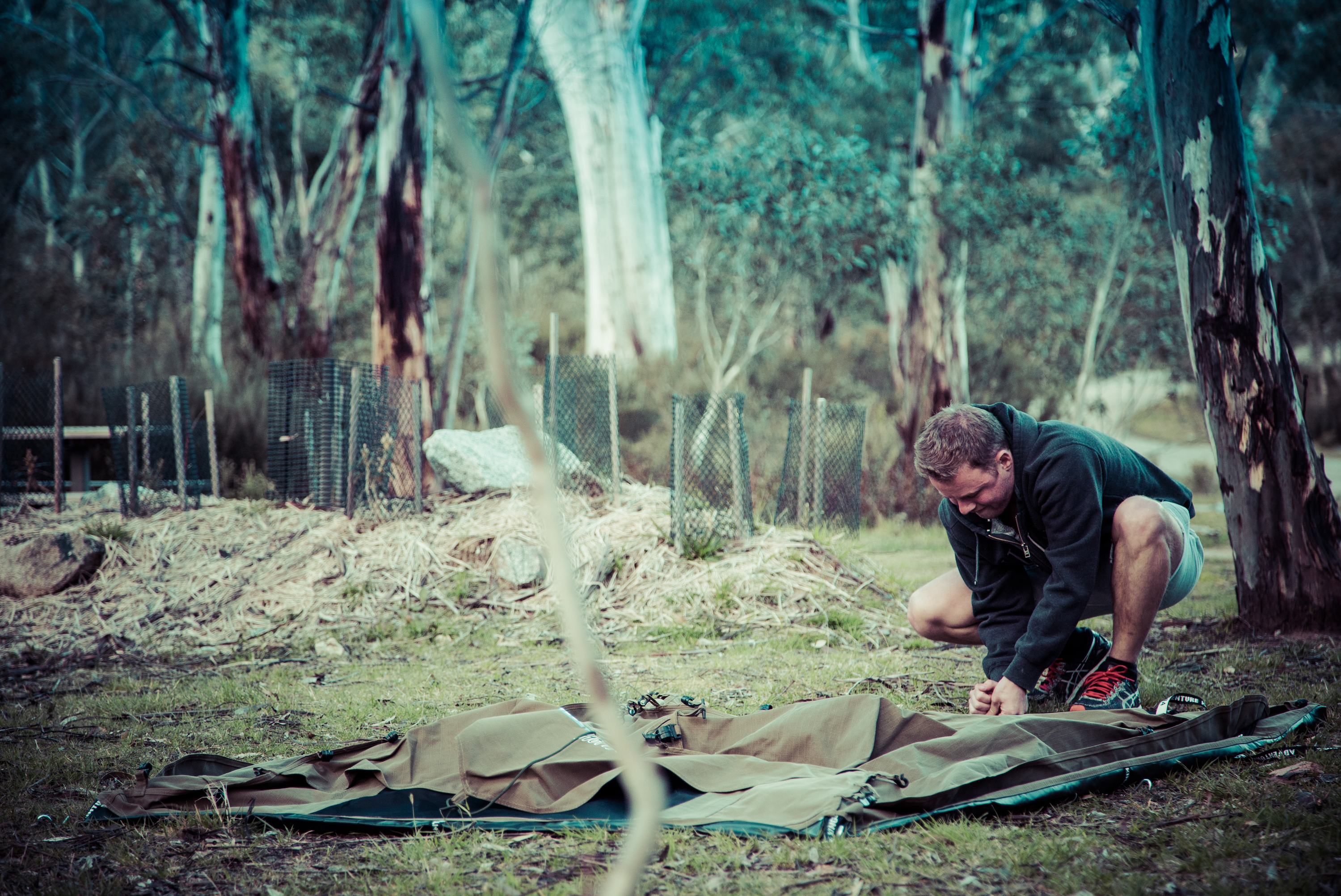 Person setting up a tent, Kosciuszko National Park. Photo: Daniel Parsons/DPIE