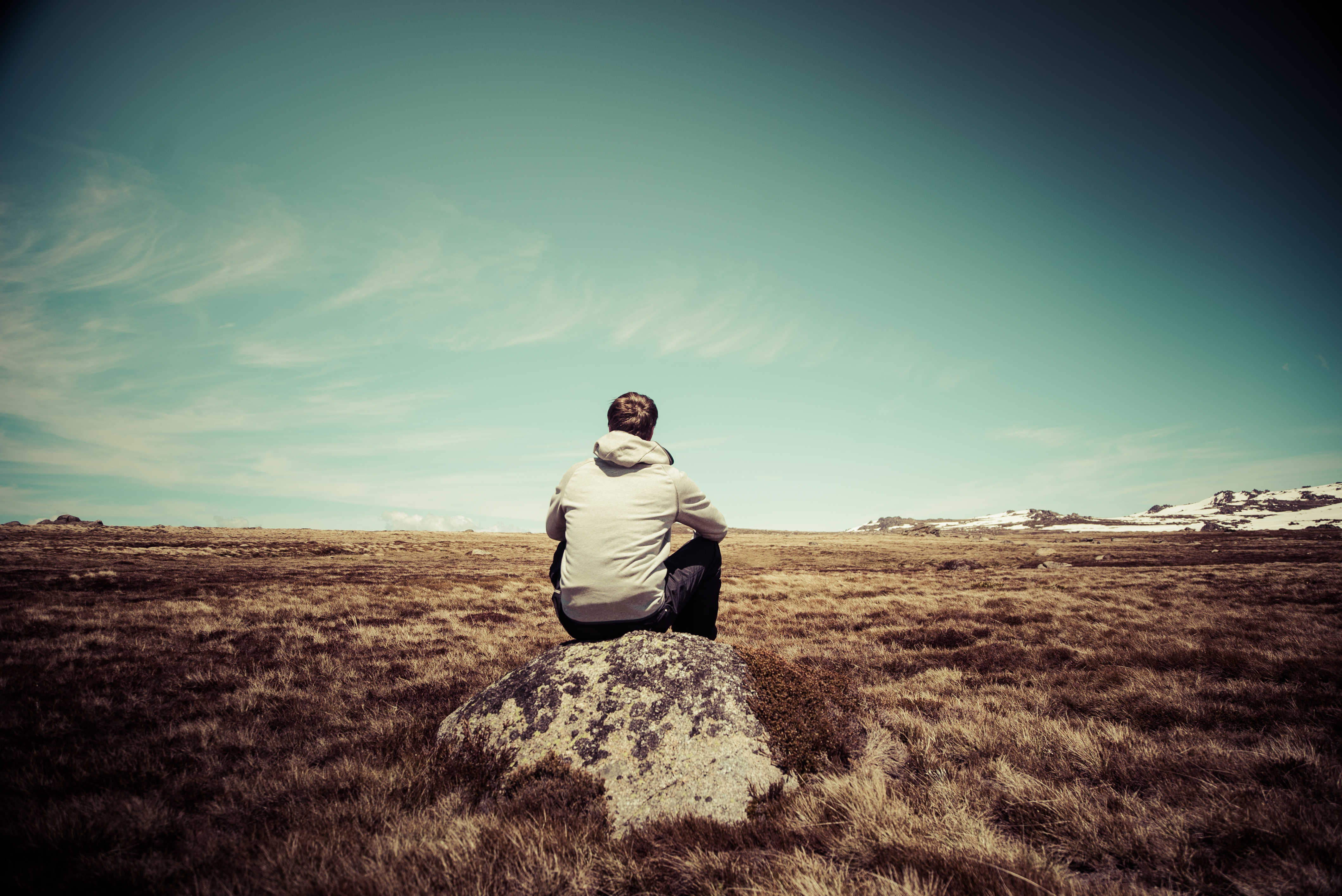 Person admiring view of Snowy Mountains, Kosciuszko National Park. Photo: Daniel Parsons/DPIE