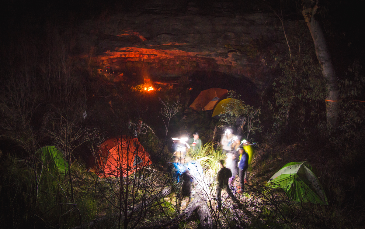 Group of people at a campground in the night. Photo: Henry Brydon