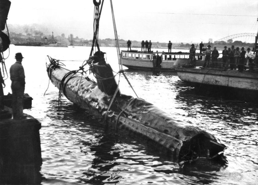 An historical image of a wrecked submarine being hauled out of Taylor’s Bay, 1943. Photo: DCCEEW