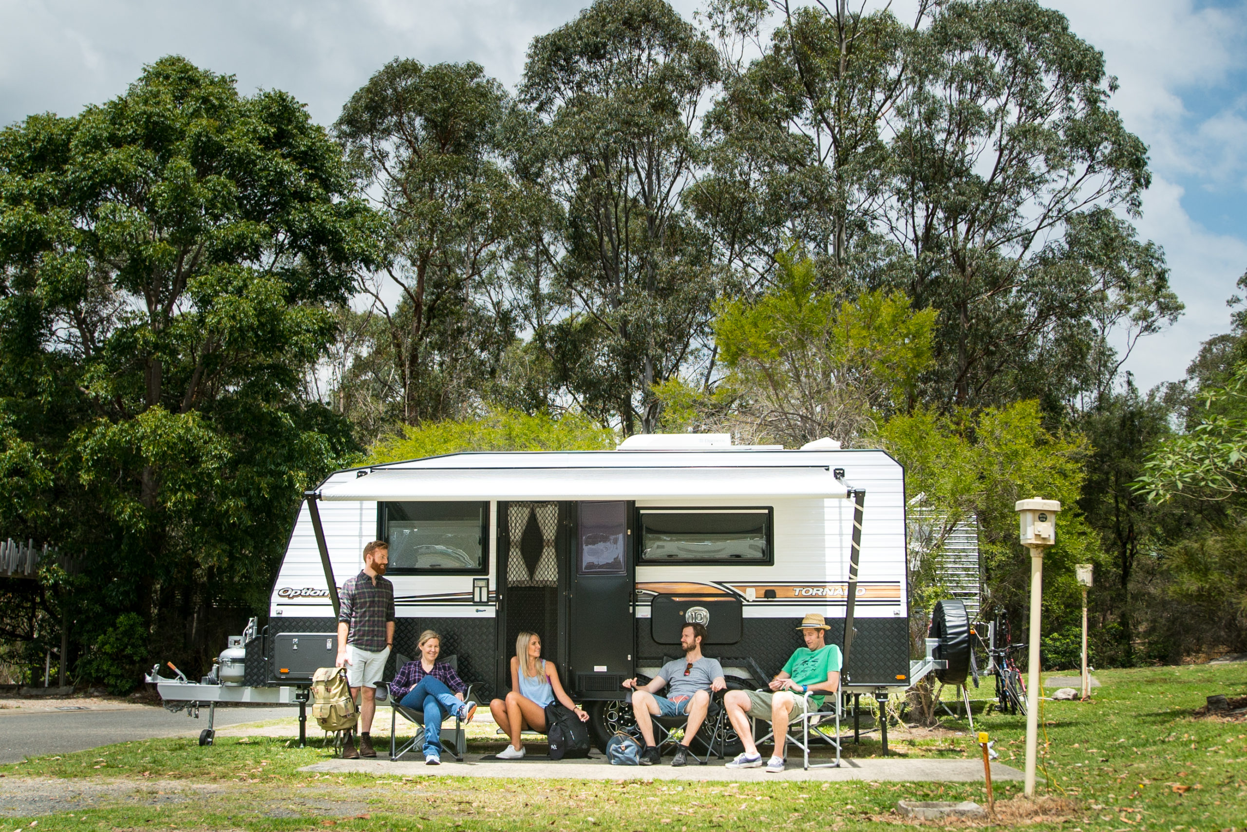 A group of people outside their camper in Lane Cove National Park. Photo credit : Daniel Parsons / DPE