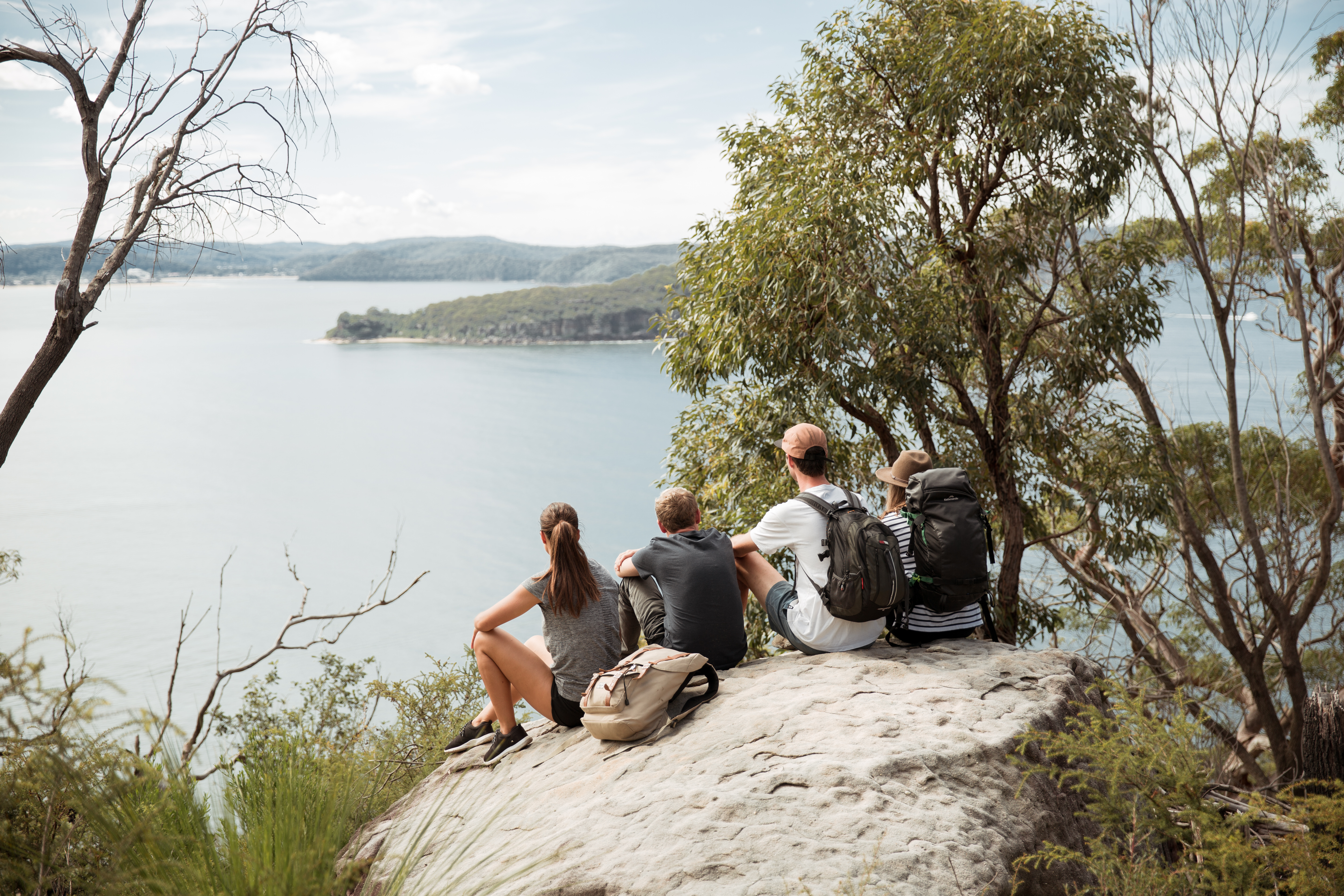 A group of people sitting on a rock, Ku-ring-gai Chase National Park. Photo credit: Tim Clark