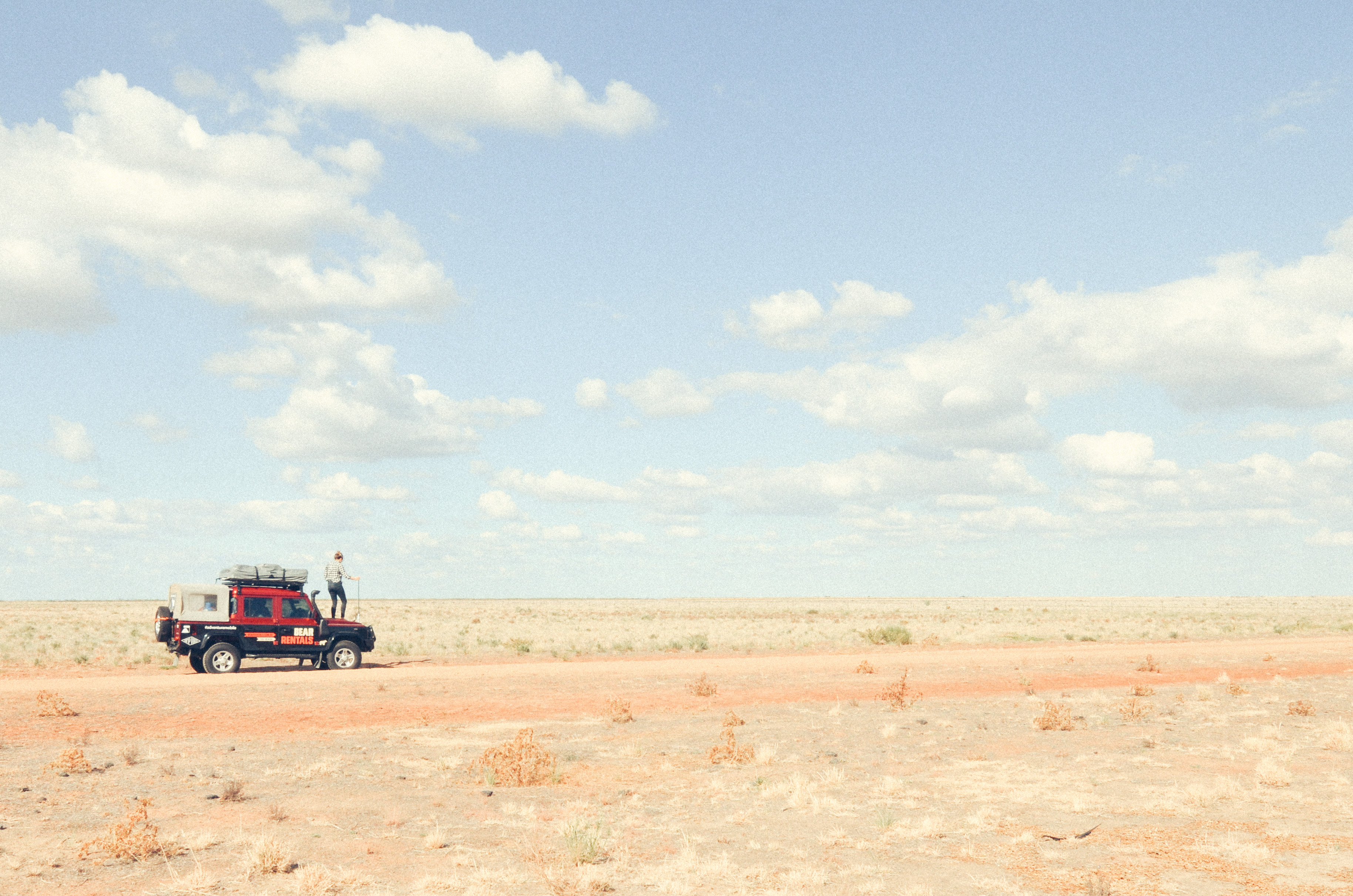 Person standing on a ute in an outback NSW national park. Photo credit: James Fyfe/DPIE