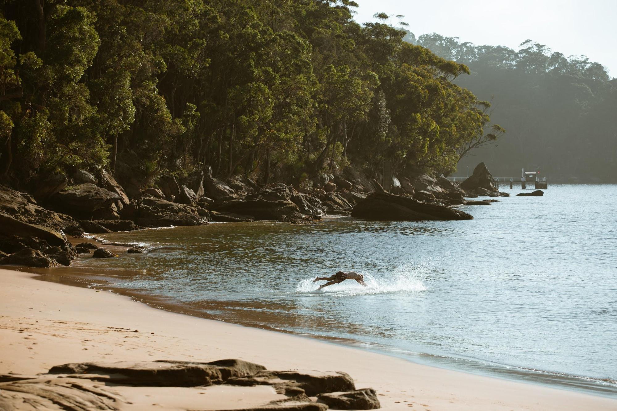 Man swimming at a beach in Ku-ring-gai Chase National Park. Photo credit: Tim Clark/DPIE