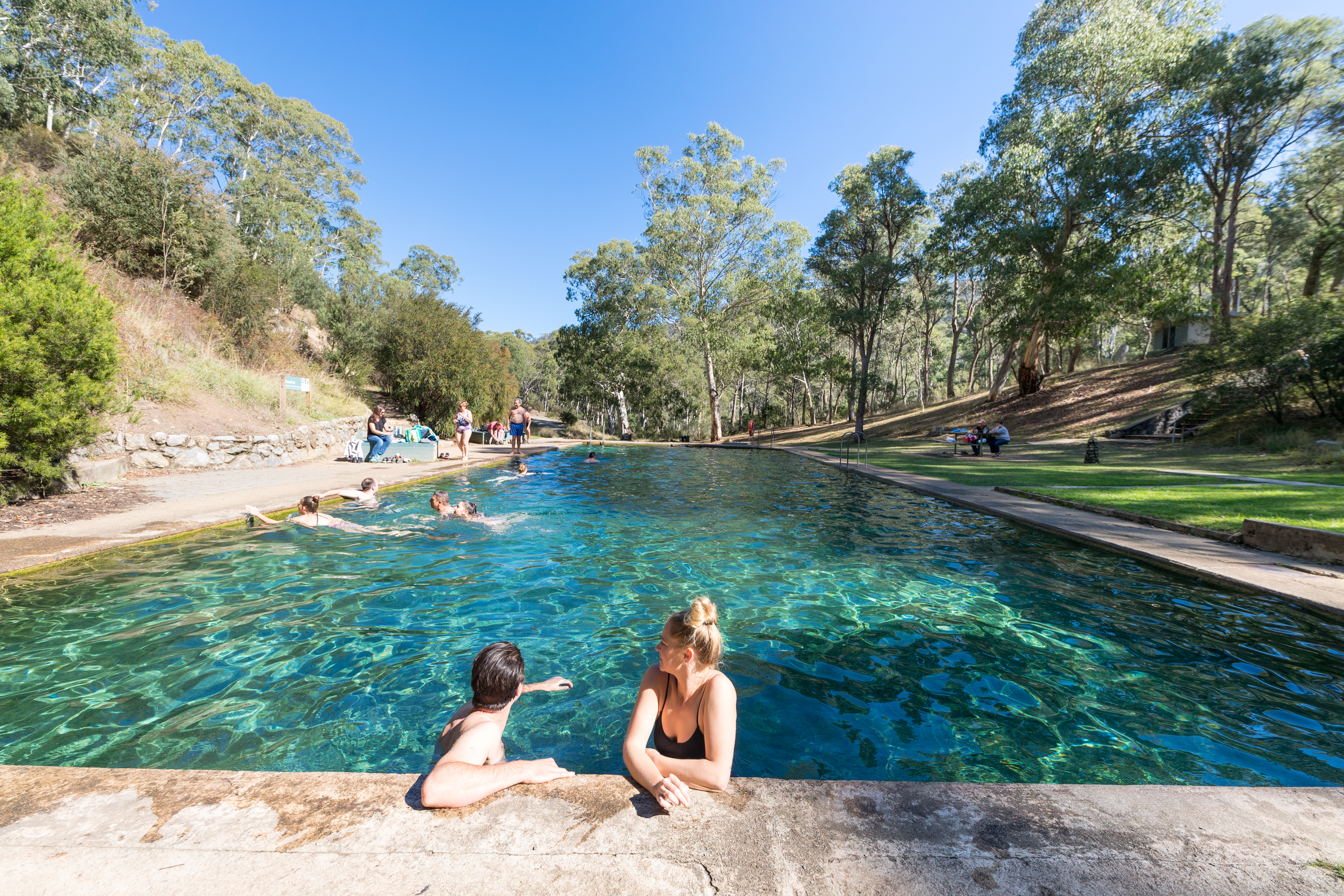 People relaxing at Yarrangobilly Caves thermal pool, Yarrangobilly area in Kosciuszko National Park. Photo credit: Boen Ferguson/DPIE