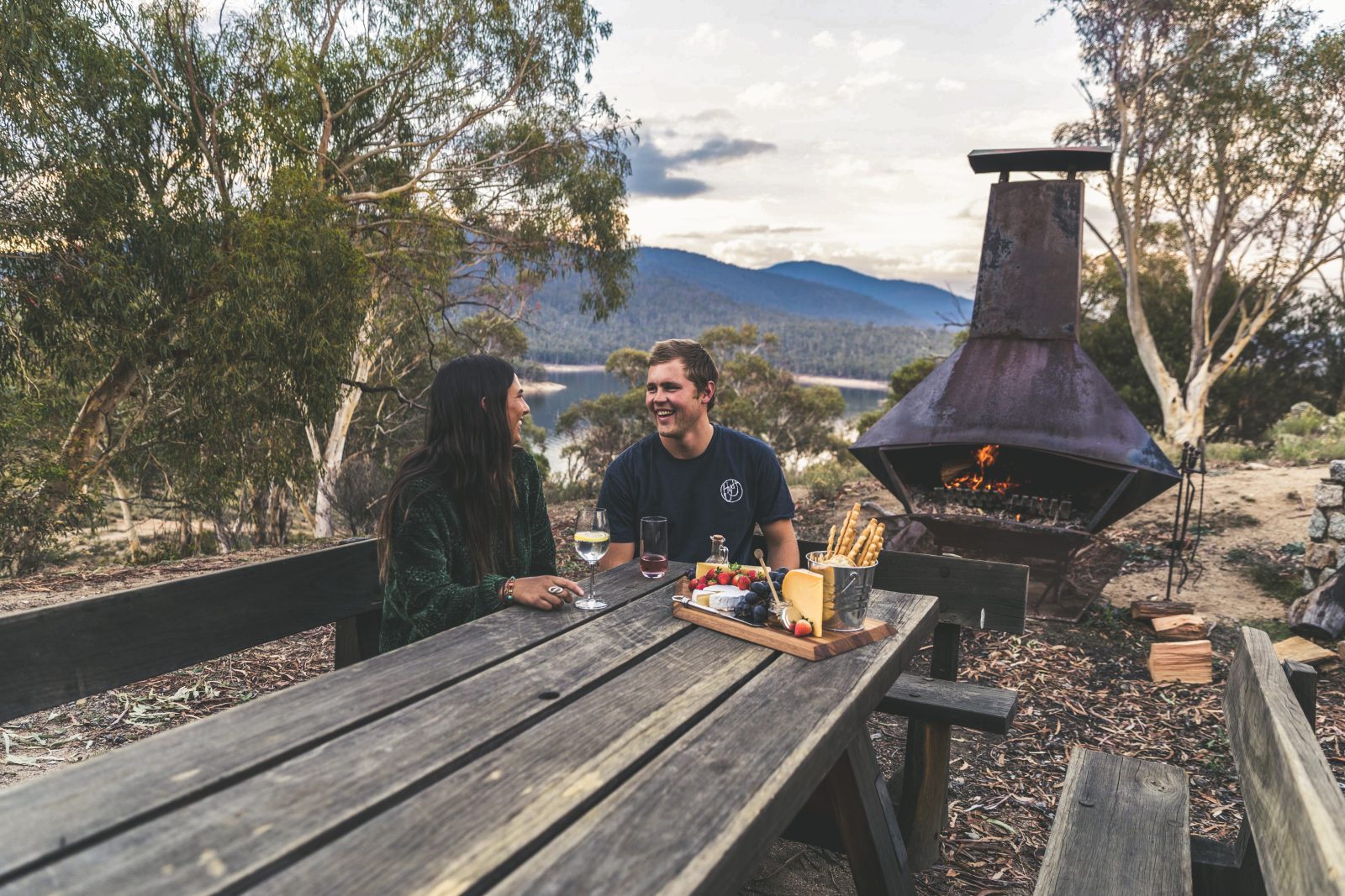 Couple sitting outside Creel Lodge in Kosciuszko National Park. Photo credit: Boen Ferguson/DPIE