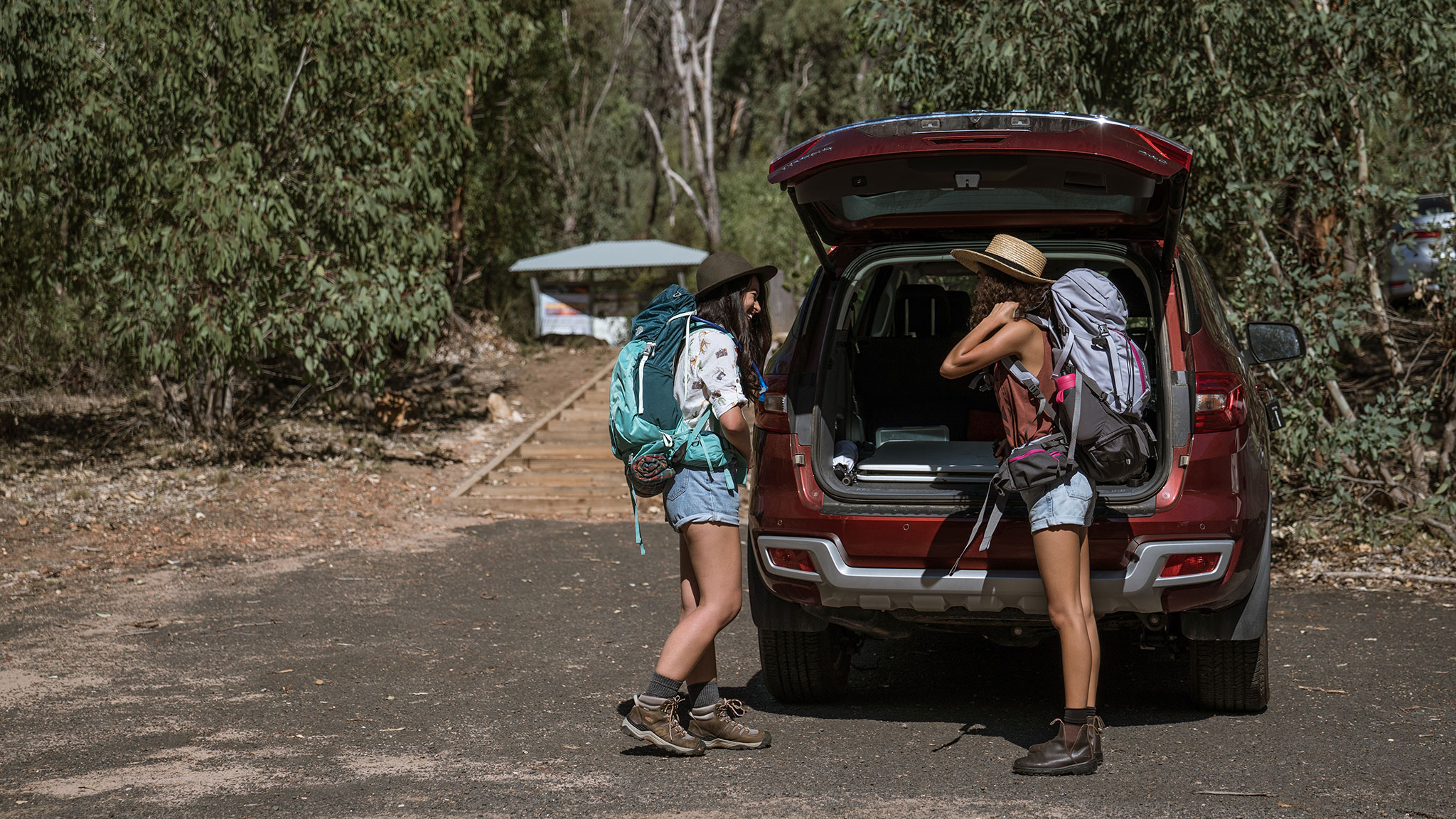 Two people preparing to go hiking in Warrumbungle National Park. Photo credit: Rob Mulally/DPIE