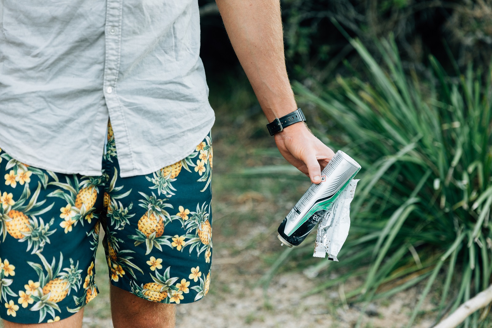 Man carrying rubbish in Murramarang National Park. Photo credit: Melissa Findley/DPIE