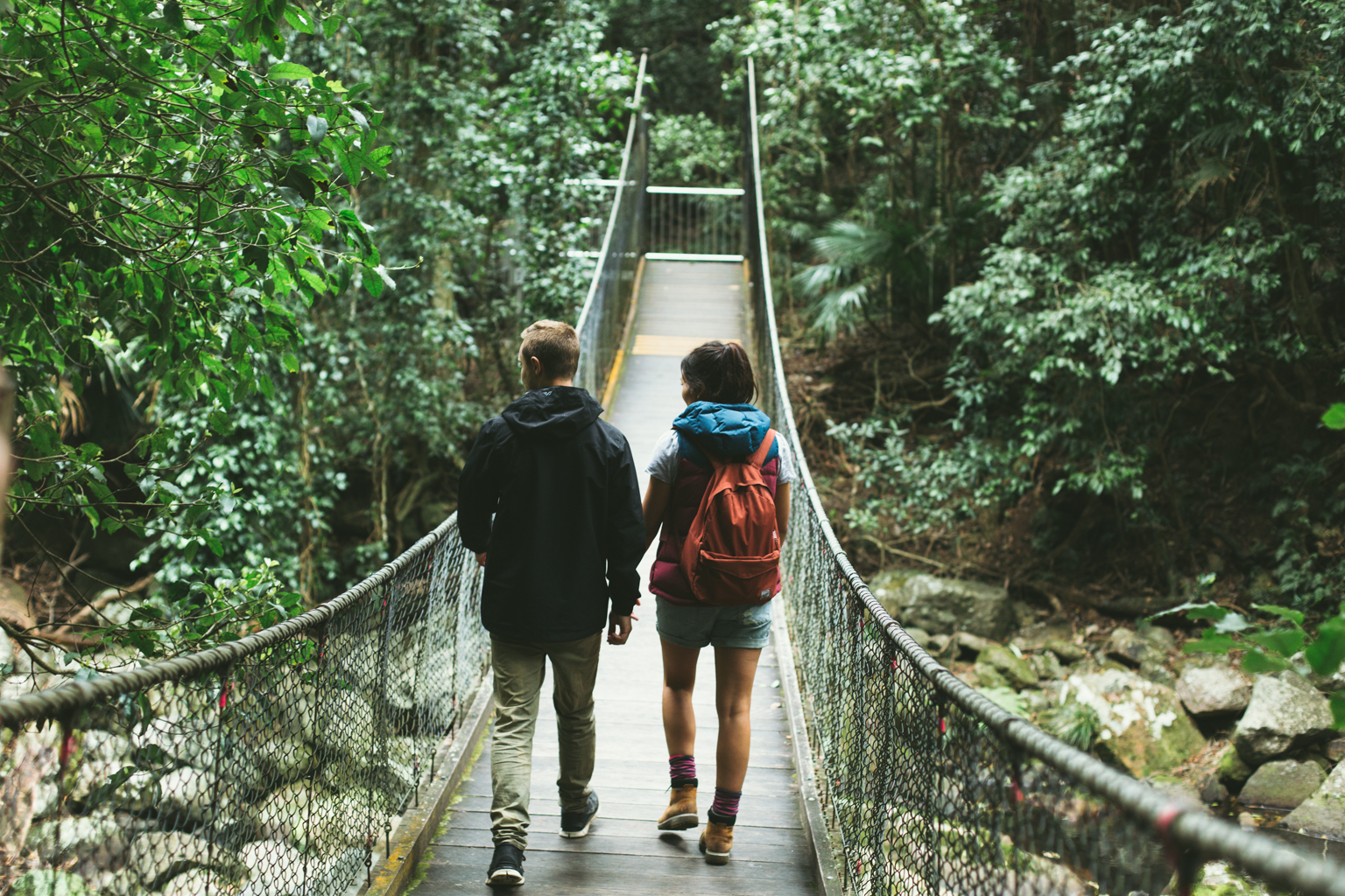 Couple walking across a bridge in Morton National Park. Photo credit: Tim Clark / DPE