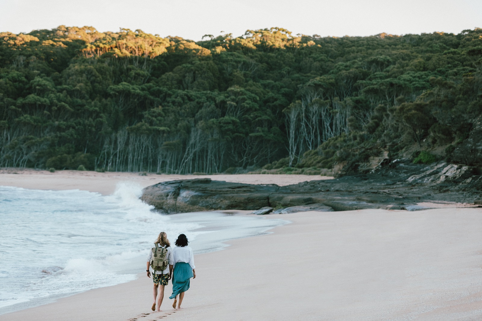 A man and woman walking along Emily Miller Beach in Murramarang National Park. Photo credit: Melissa Findley/DPIE
