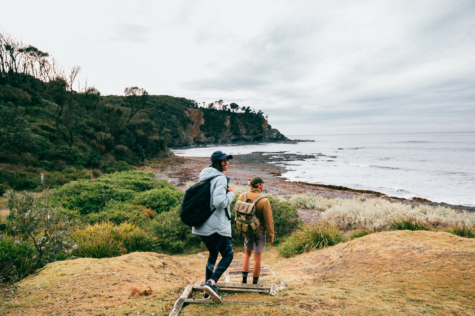 A woman and man taking a walk from Honeysuckle Beach in Murramarang National Park. Photo credit: Melissa Findley/DPIE