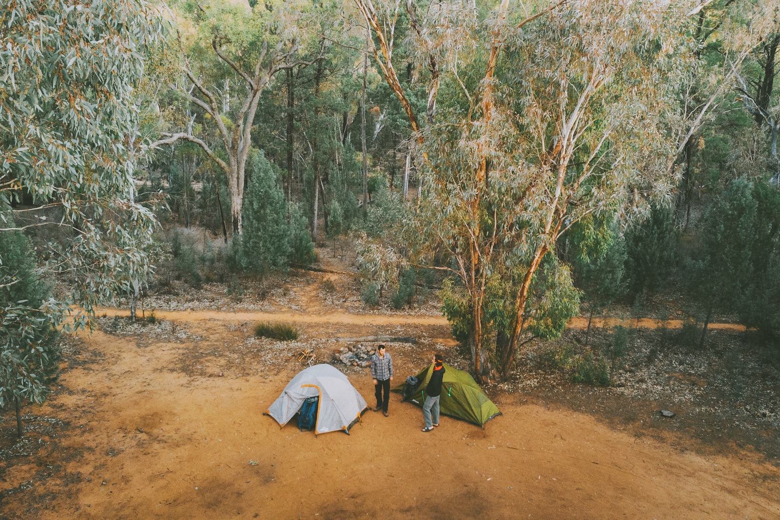 Aerial view of two men and tents at Sculptures in the Scrub campground. Photo: Harrison Candlin/DCCEEW © Harrison Candlin