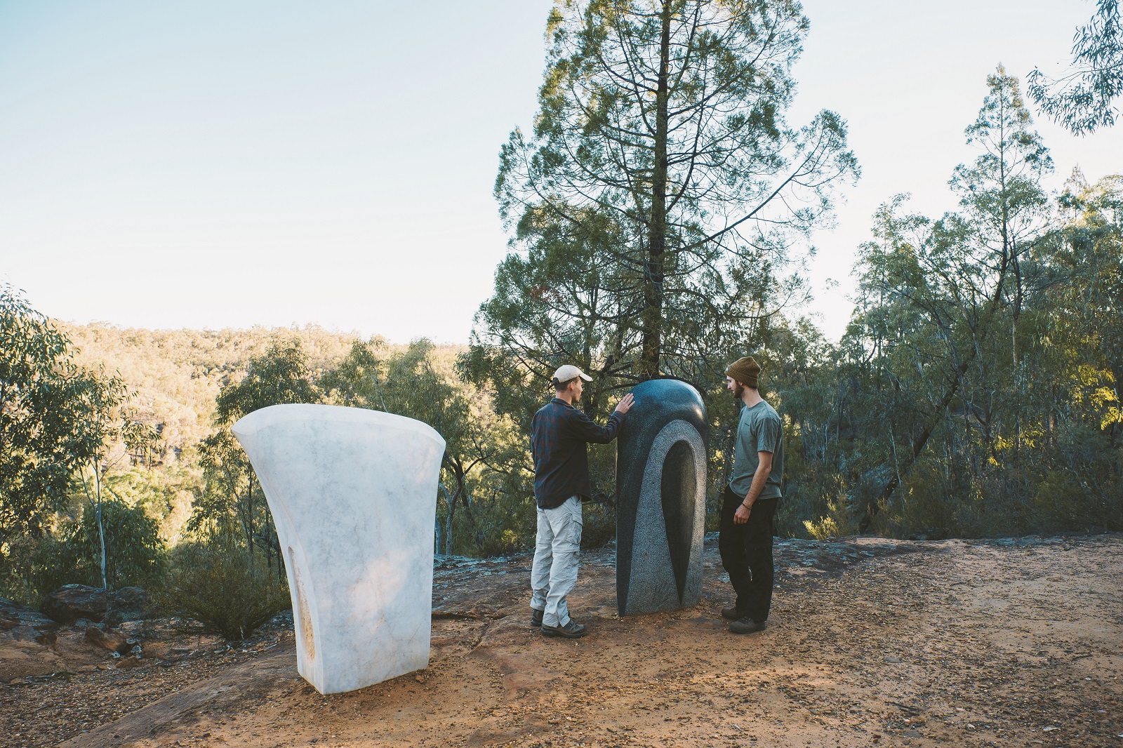 Two men admiring the sculptures on the Sculptures in the Scrub walking track in Timmallallie National Park. Photo: Harrison Candlin/DCCEEW © Harrison Candlin