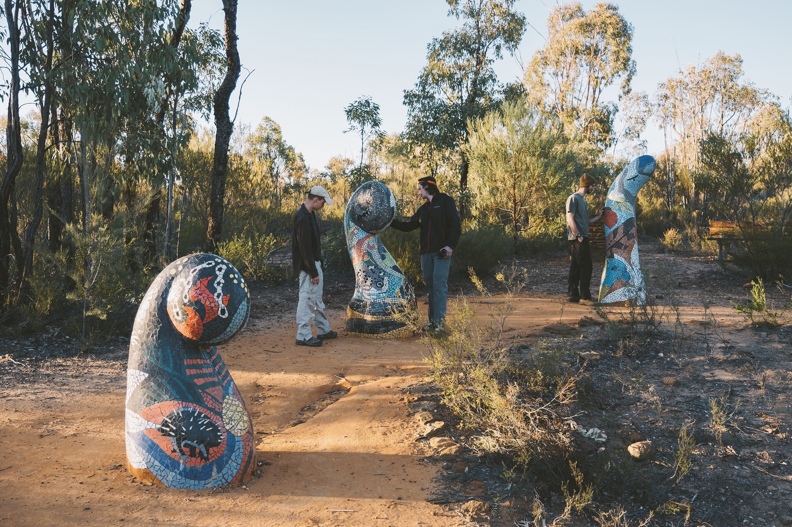 People admiring sculptures along the Sculptures in the Scrub walking track. Photo: Harrison Candlin/DCCEEW © Harrison Candlin
