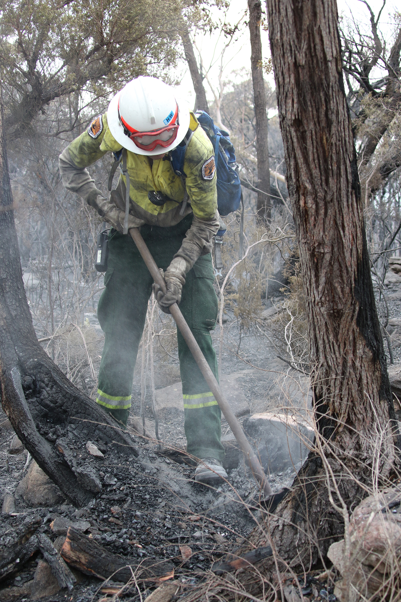 NPWS firefighter using a rake hoe. Photo credit: David Croft/DPIE