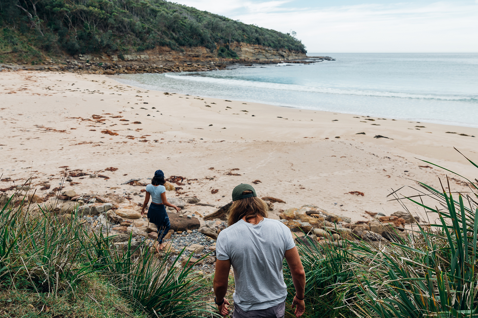 Two people walking towards the beach, Murramarang National Park. Photo credit: Melissa Findley/DPIE