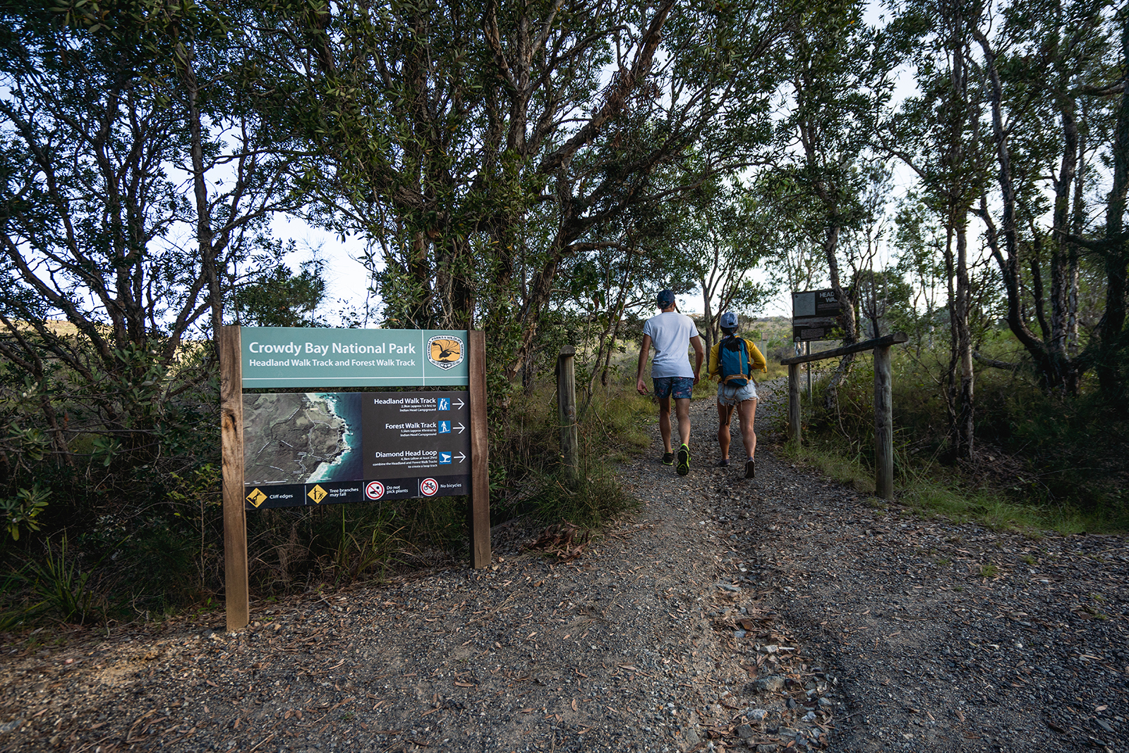 Two people on hiking towards Forest walking track, Crowdy Bay National Park. Photo credit: Rob Mulally/DPIE