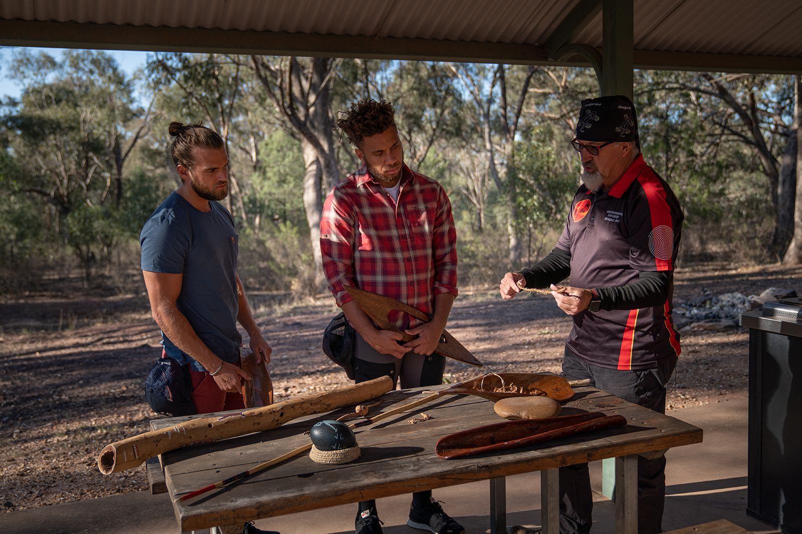 Two guys at Kengal (The Rock) Picnic Area learning about Aboriginal Wiradjuri culture and the significance of Kengal on a tour with an NPWS tour operating partner. Photo credit: Rob Mulally/DPIE