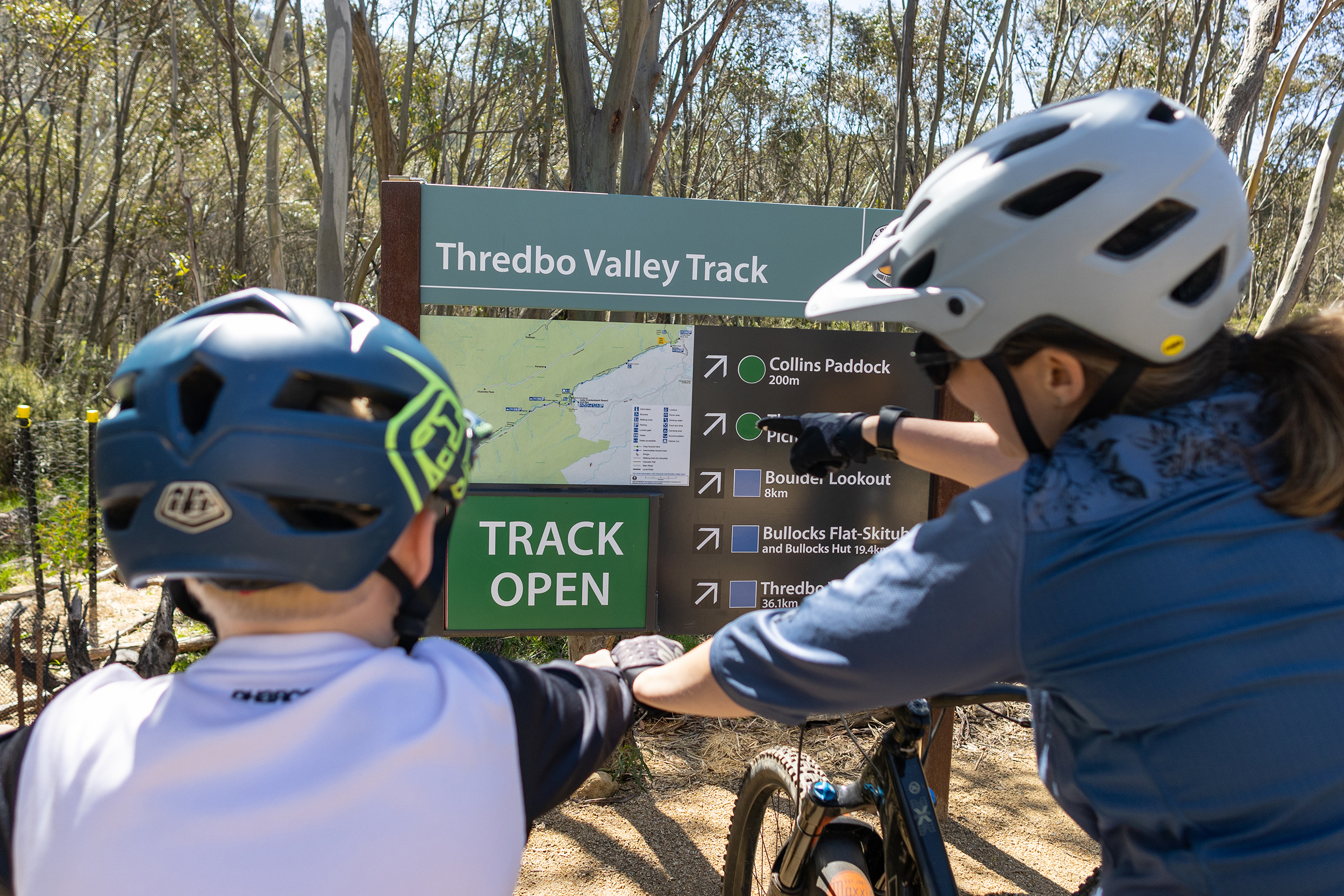 A woman and child looking at a the Gaden Bridge to Thredbo River Picnic Area track sign , Kosciuszko National Park. Photo credit : Boen Ferguson / DPE