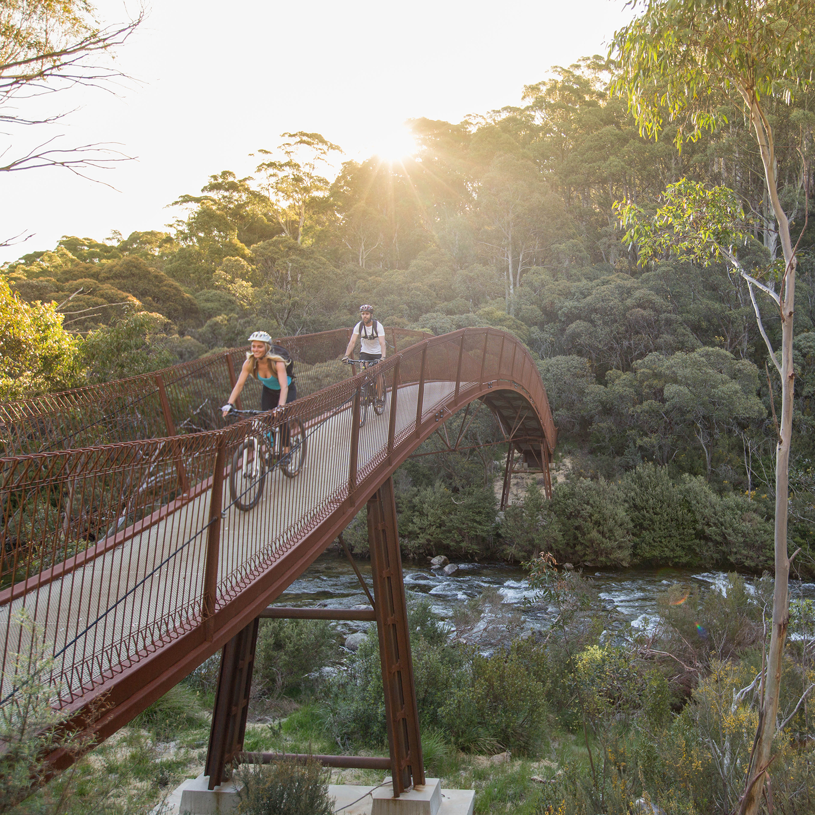 Two people riding on Bridge 5, Thredbo Valley track, Thredbo-Perisher area in Kosciuszko National Park. Photo credit: Boen Ferguson/DPIE