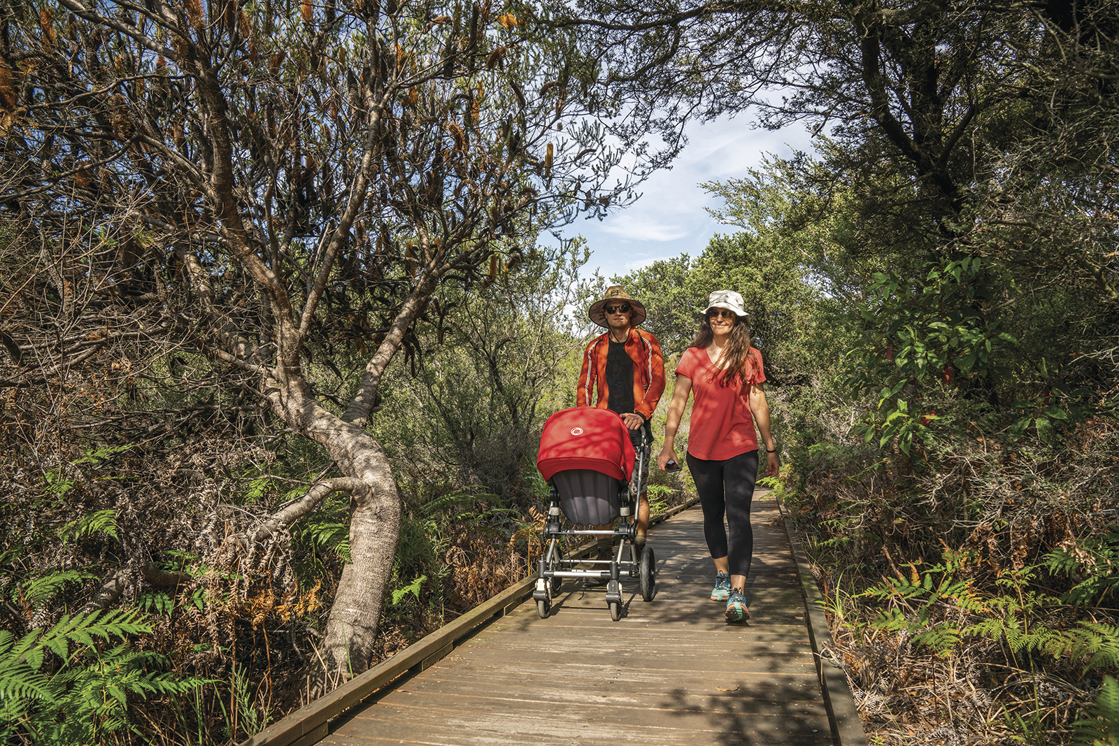 Two people and a pram walking along Jennifer St Boardwalk, Kamay Botany Bay National Park. Photo Credit : John Spencer/DPIE