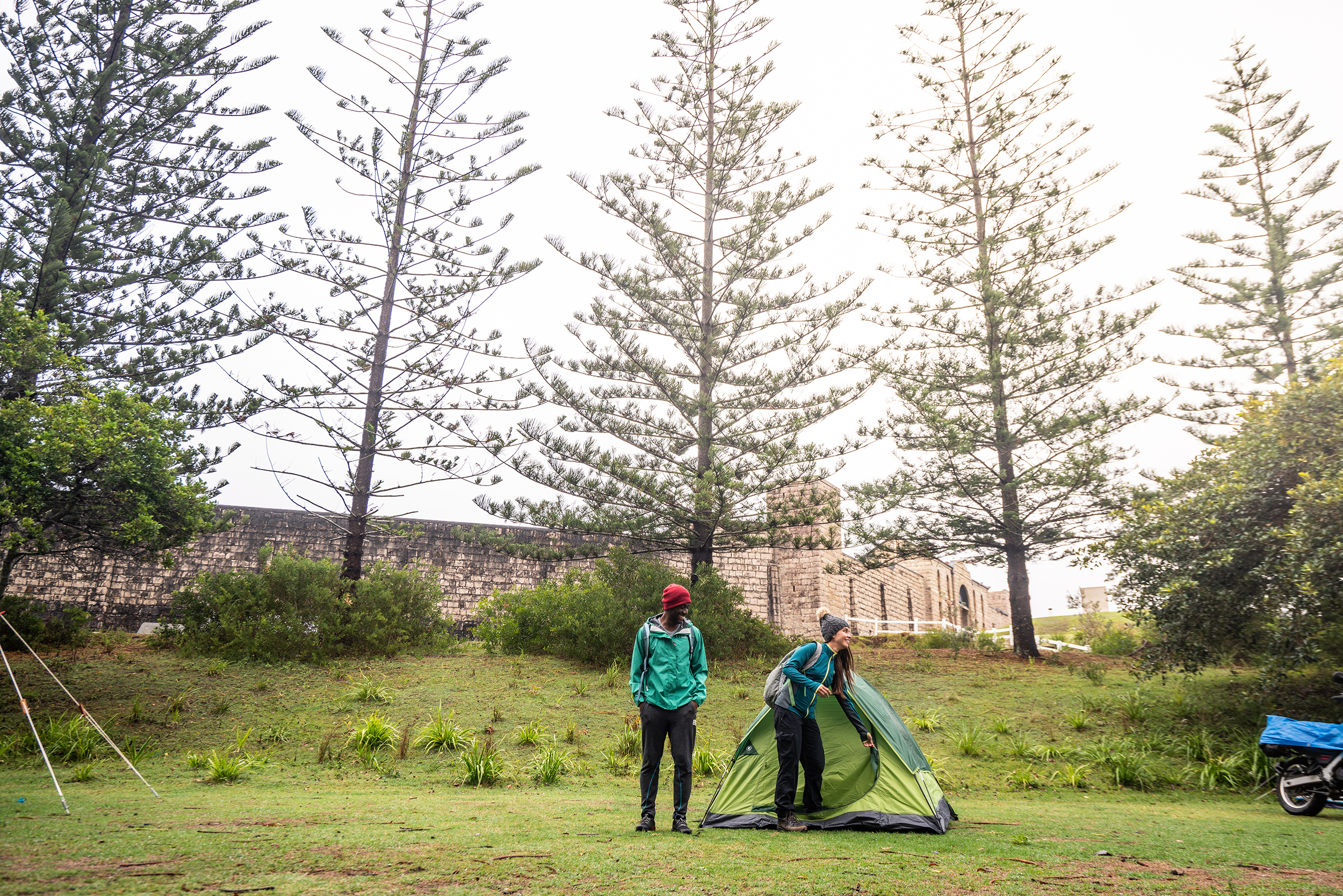 Two people next to a tent in Trial Bay Goal campground, Arakoon National Park. Photo credit: Rob Mulally / DPIE