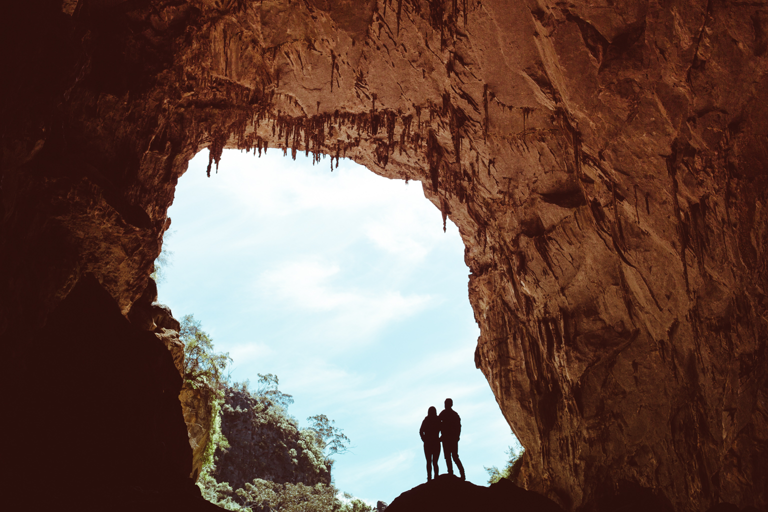 Silhouette of two people in a cave of Jenolan Karst Conservation Area. Photo credit: Tim Clark
