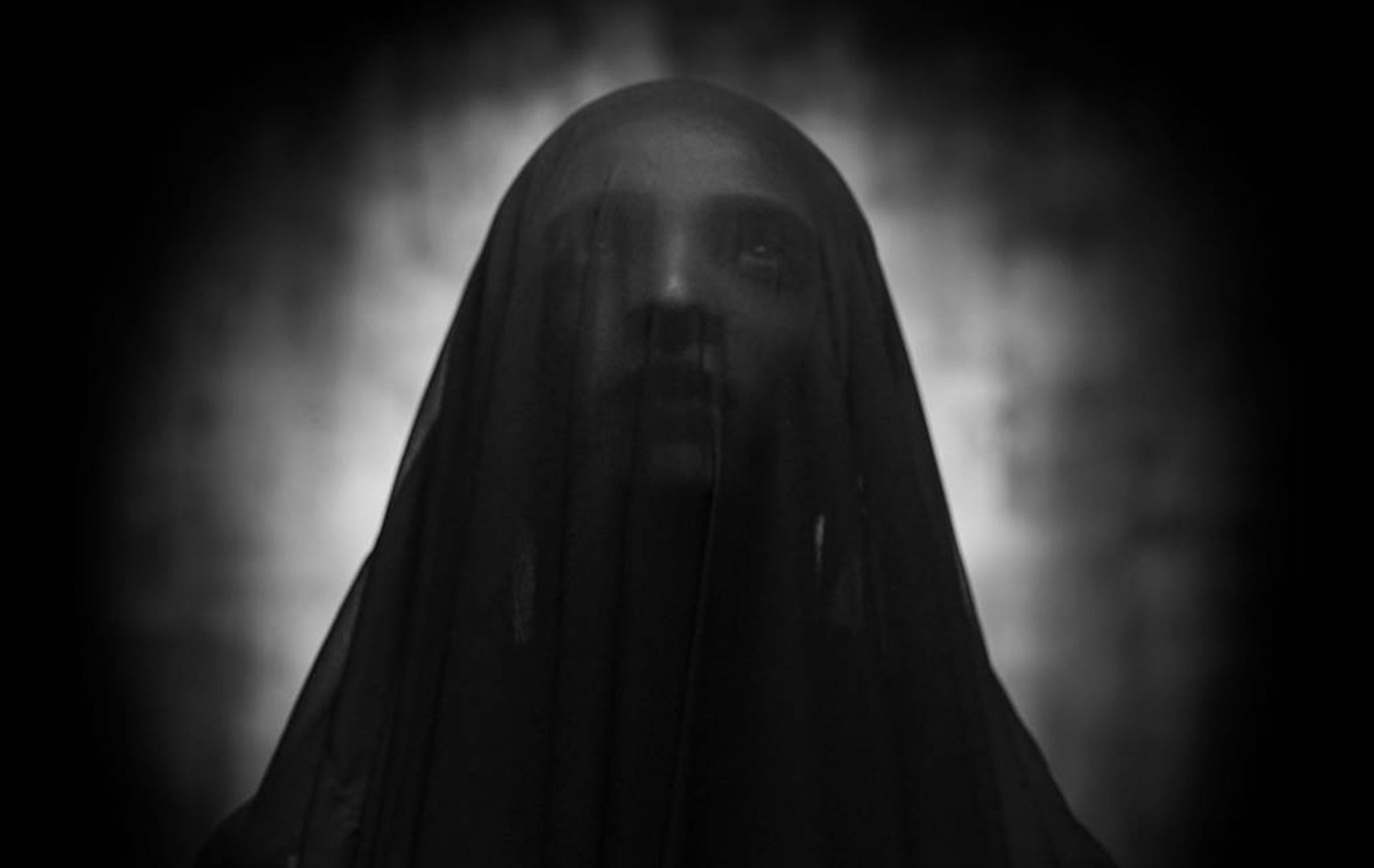 Shadowed image of a person with head covering. Photos: © Faizi Ali via Pexels