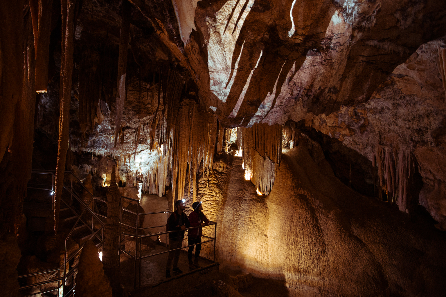 Two people on a guided tour in Jenolan Caves. Photo Credit: Tim Clark / DPIE