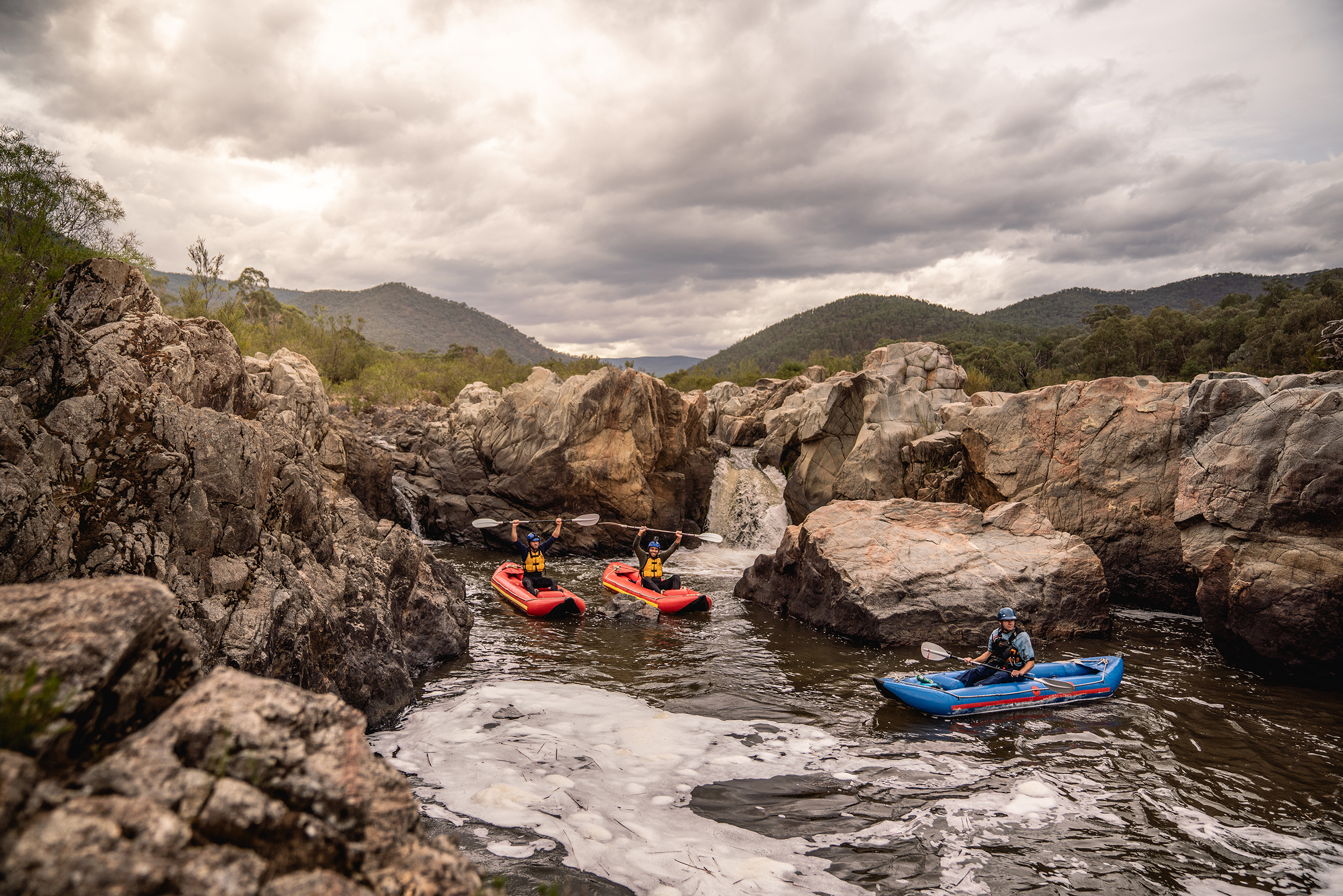 Three people in kayaks on the snowy river., on a guided kayaking tour. Photo credit : Rob Mulally / DCCEEW © Studio Bilby