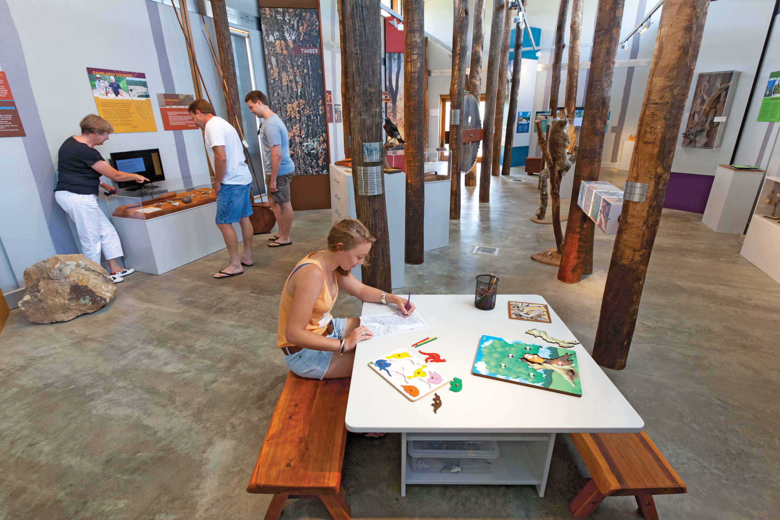 A person inside on the interactive displays in the Pilliga Forest Discovery Centre indoors. Photo credit: Robert Cleary / DPE