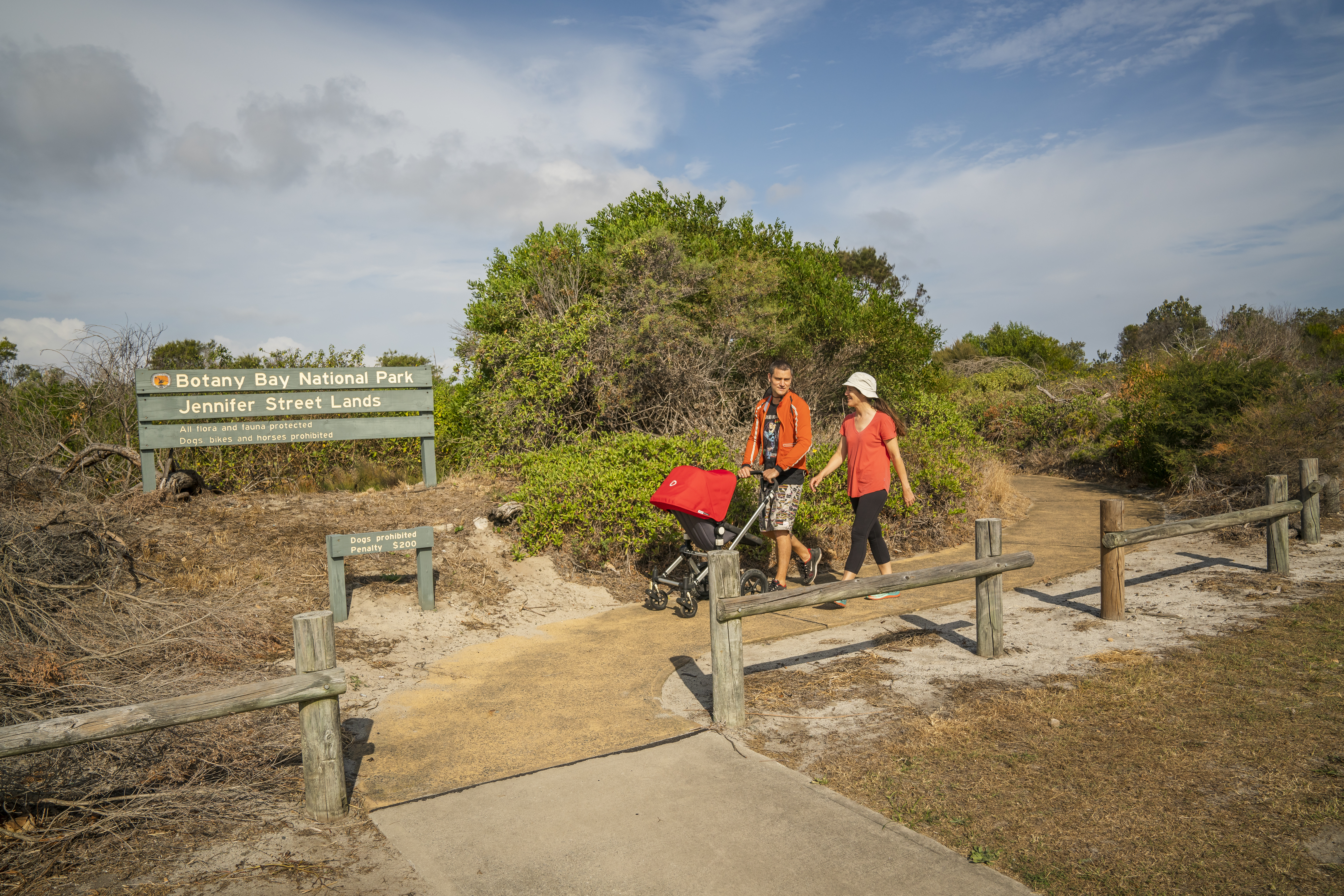 Couple with pram walking along Jennifer Street Boardwalk, Kamay Botany Bay National Park. Photo credit: John Spencer / DPE