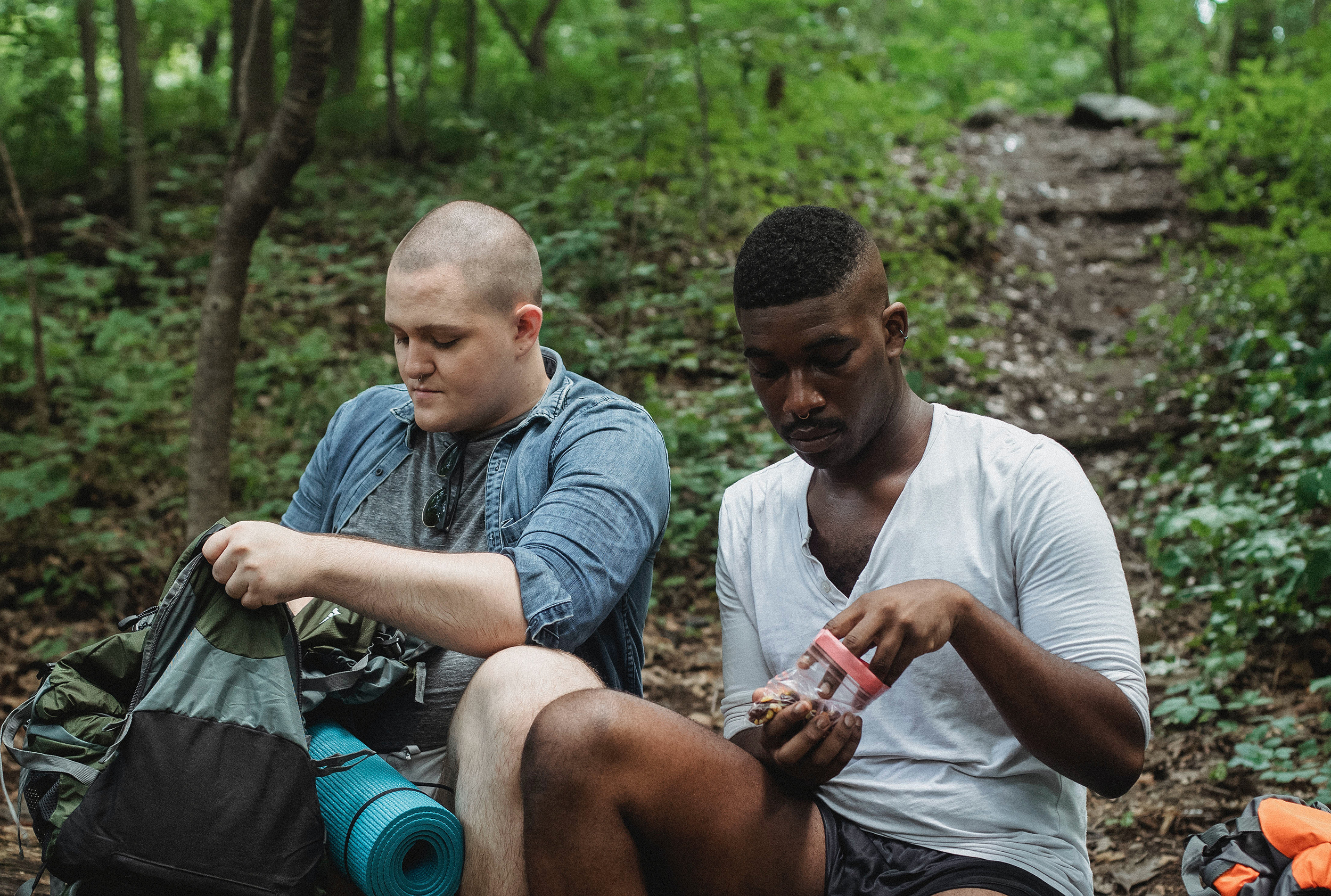 Friends having a snack while camping. Photo: Kamaji Ogino via Pexels