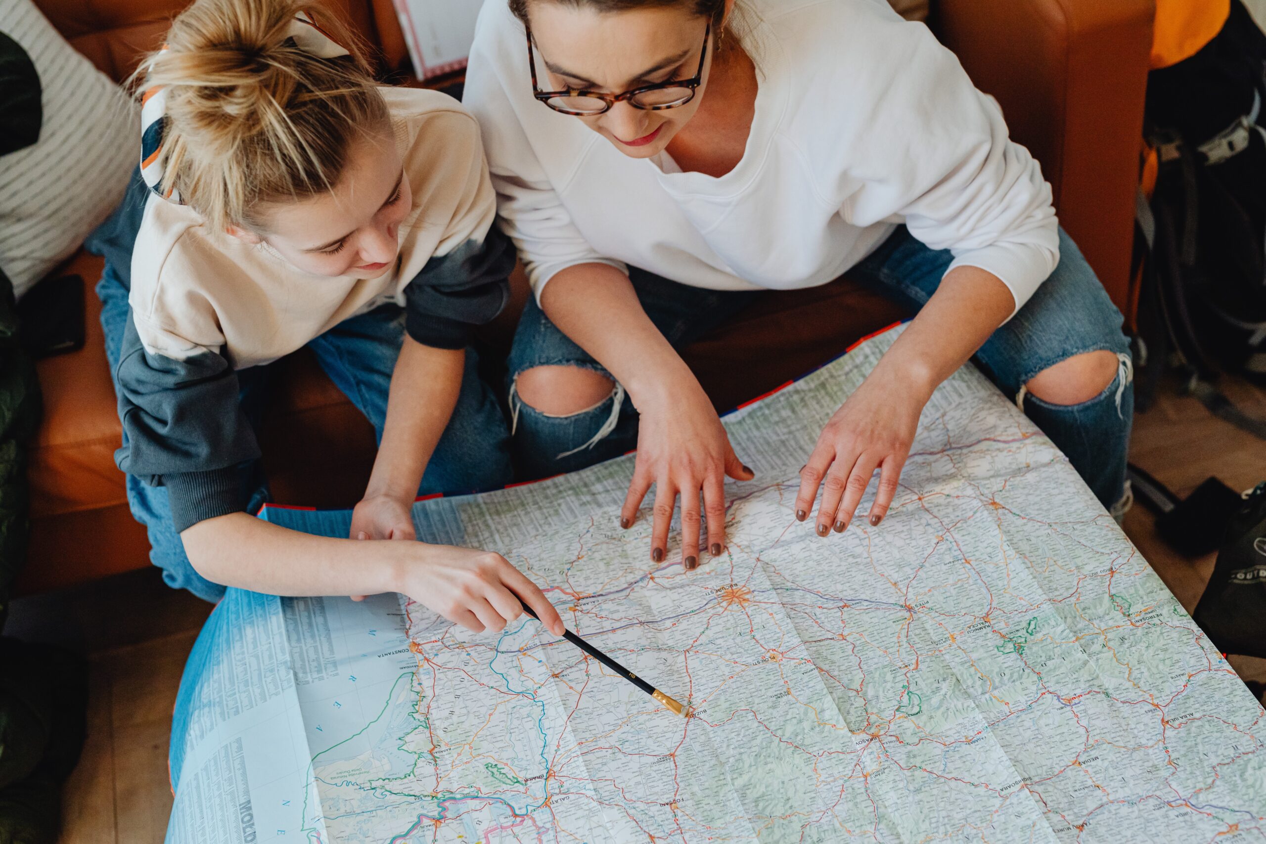 Two people reviewing a map. Photo credit: Karolina Grabowska via Pexels