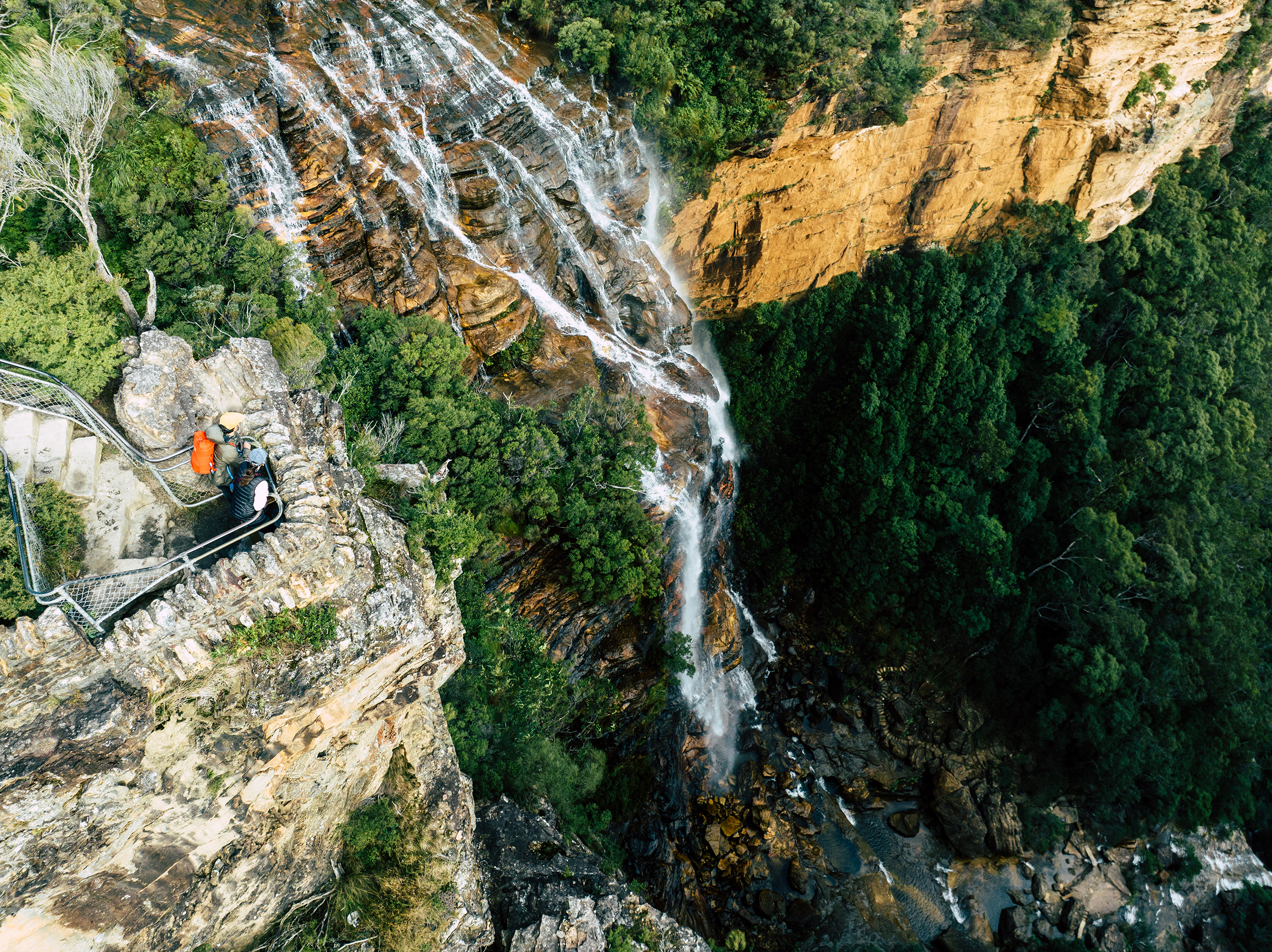 Aerial view of two people at Fletchers Lookout, Grand Cliff Top Walk,, Blue Mountains National Park. Photo: Remy Brand / DCCEEW © Studio Bilby