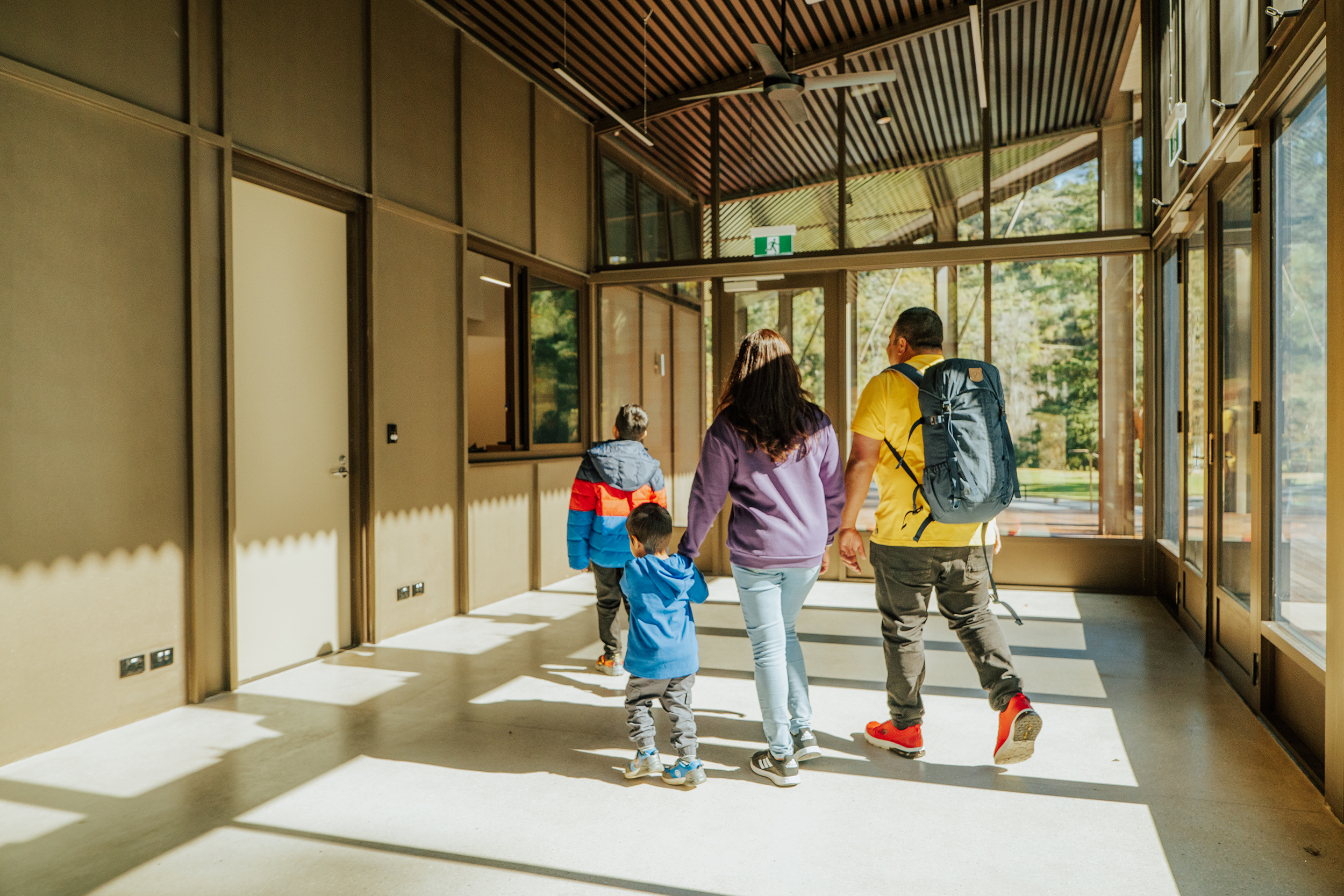 A family of four walking to the Wombeyan Caves office counter. Photo credit: Remy Brand / DCCEEW