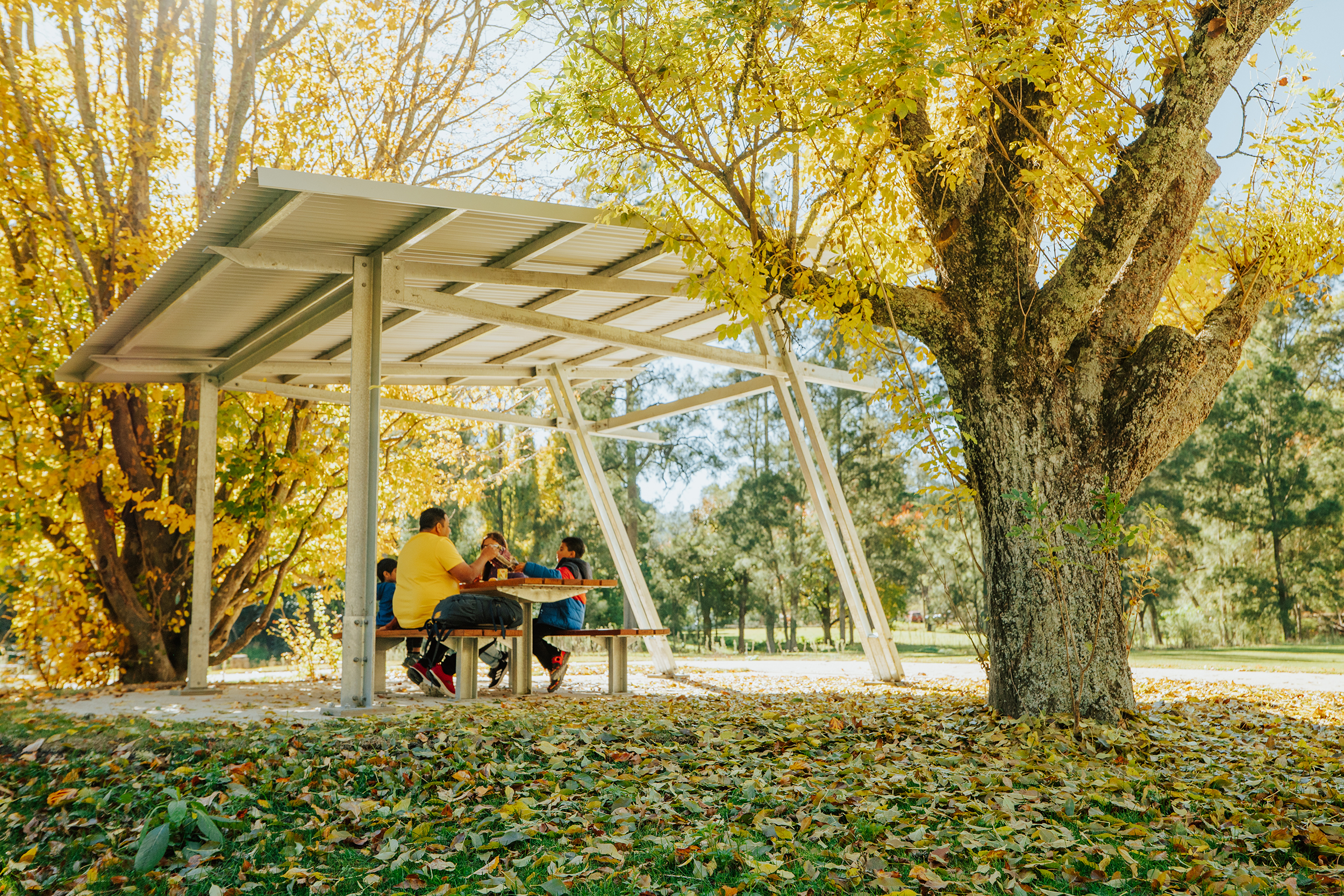 A family of four having a snack at the picnic area. Womebyan Caves, Wombeyan Karst Conservation Area. Photo credit: Remy Brand / DCCEEW