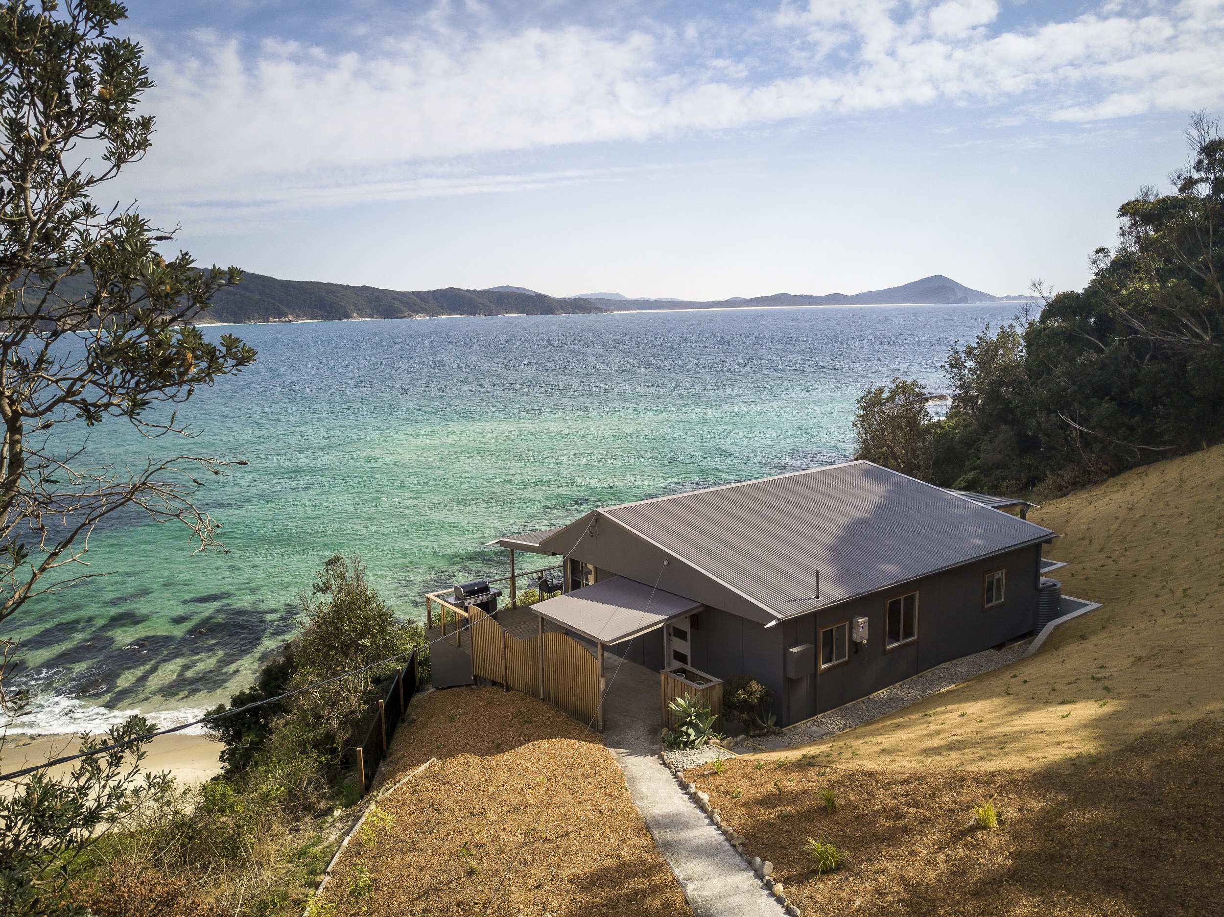 The path to Davies Cottage with an ocean backdrop. Photo credit: Brent Mail/DCCEEW